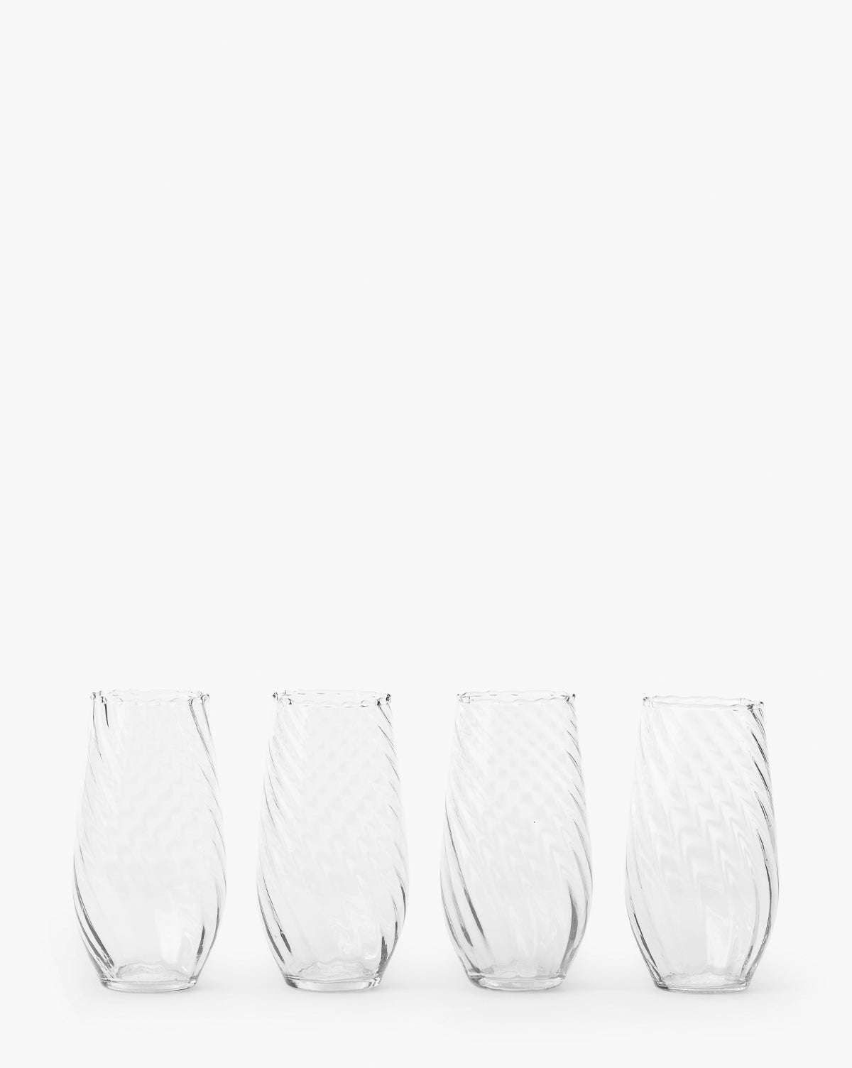The Adderley Highball Glasses (Set of 4) feature clear, stemless designs with a subtle swirling pattern, crafted from mouth-blown glass and arranged in a row against a plain white background by McGee & Co.