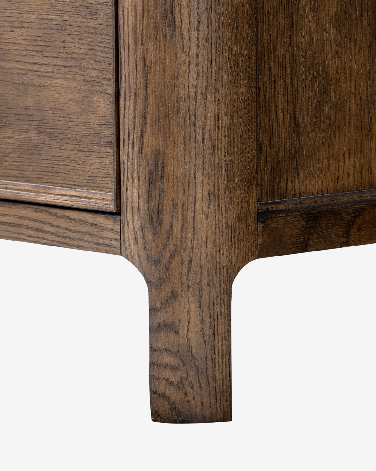 Close-up of the Aeris Nightstand’s bottom corner and leg, highlighting its wood grain texture and natural brown finish—ideal for stylish bedroom organization and storage, by McGee & Co. White background.