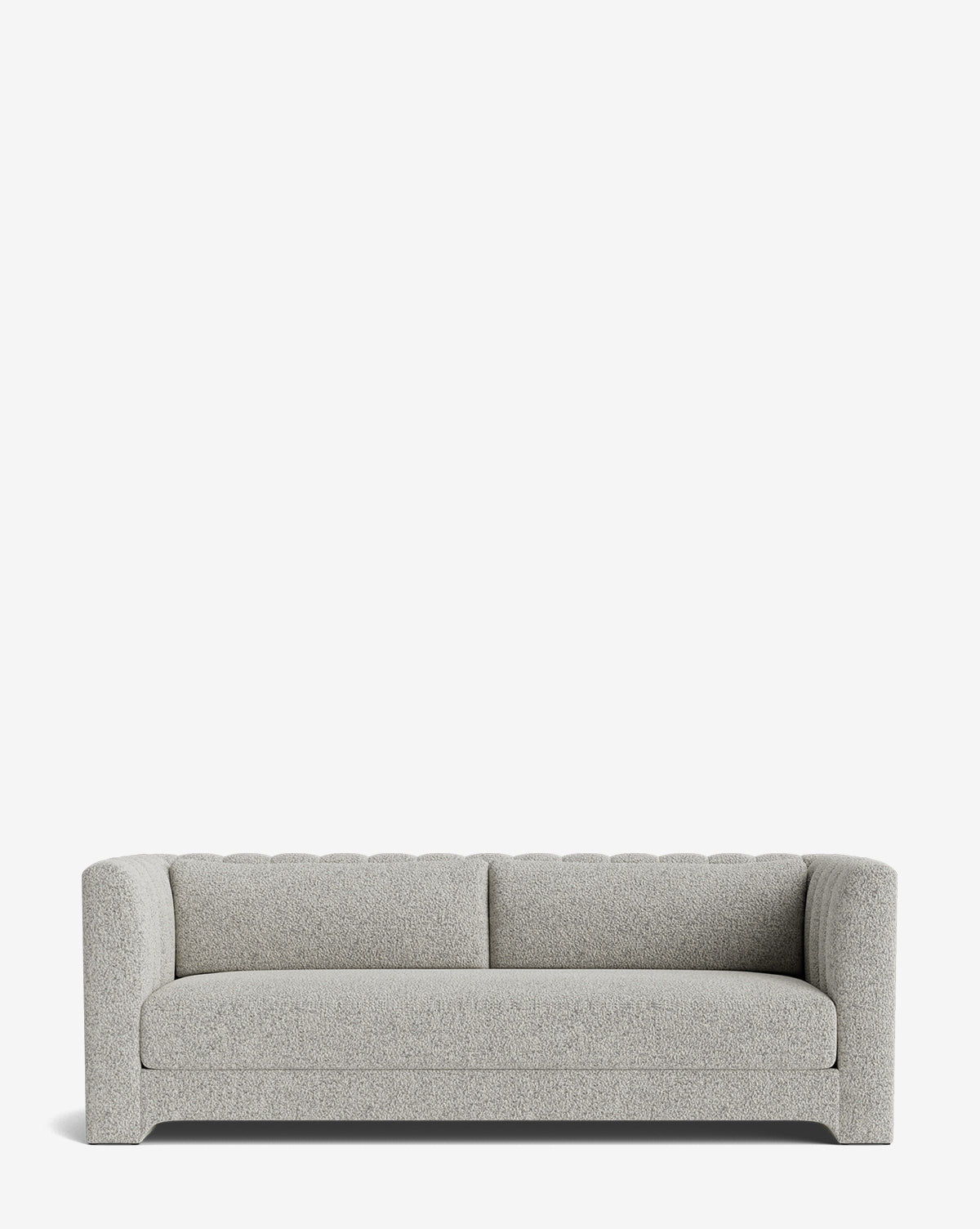 The Agatha Sofa 90 is a modern, light gray upholstered piece with thick padded arms and backrest, boxy minimalist design, short legs, and tufted backrest detailing. Handcrafted for comfort and style, by McGee & Co.