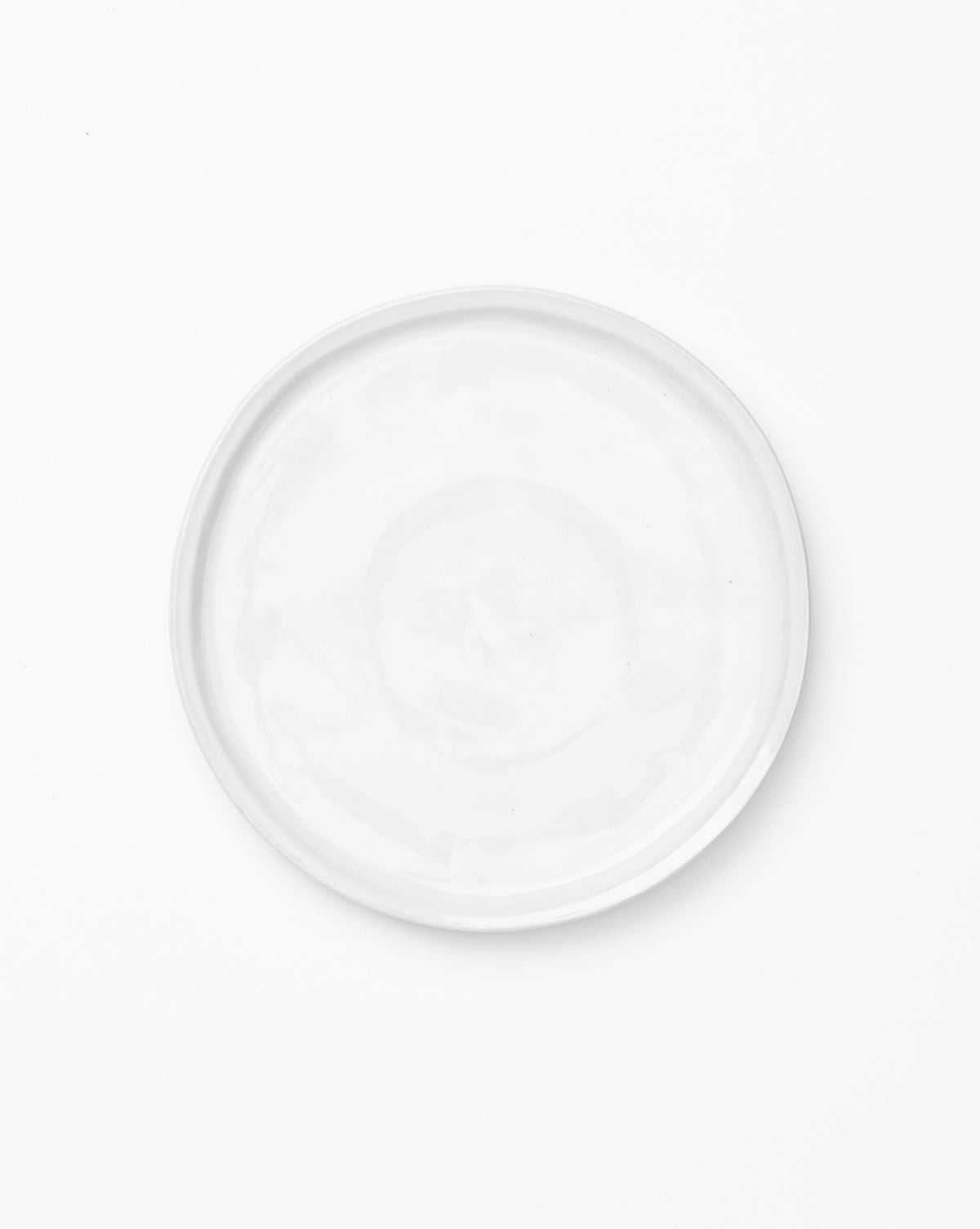 The Aiden Side Plate, a plain round white plate, is photographed from above against a white background by McGee & Co.
