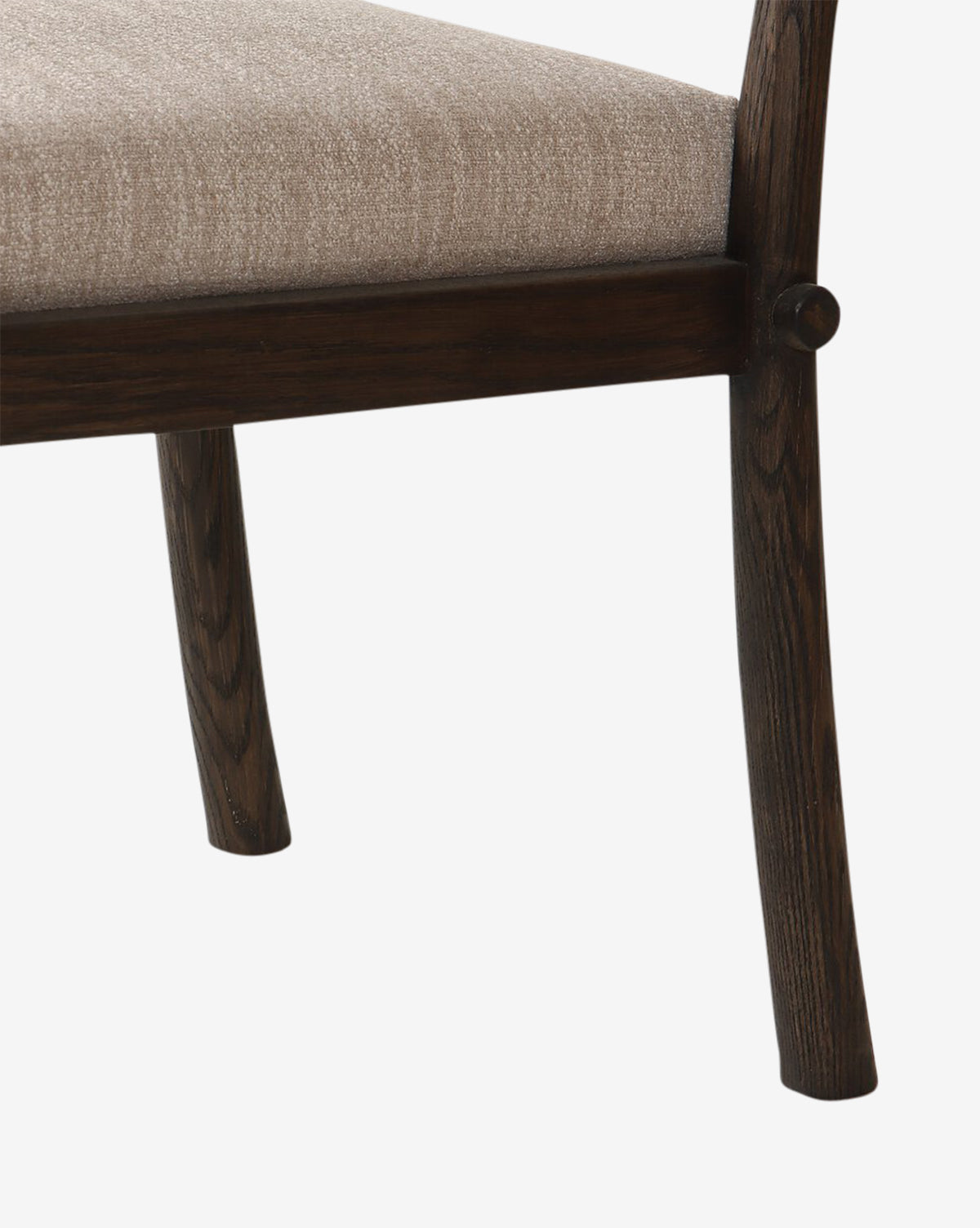 Close-up of the Ailsa Dining Chair featuring two dark wooden legs and a seat in light beige fabric, highlighting its modern elegance against a plain white background, by McGee & Co.