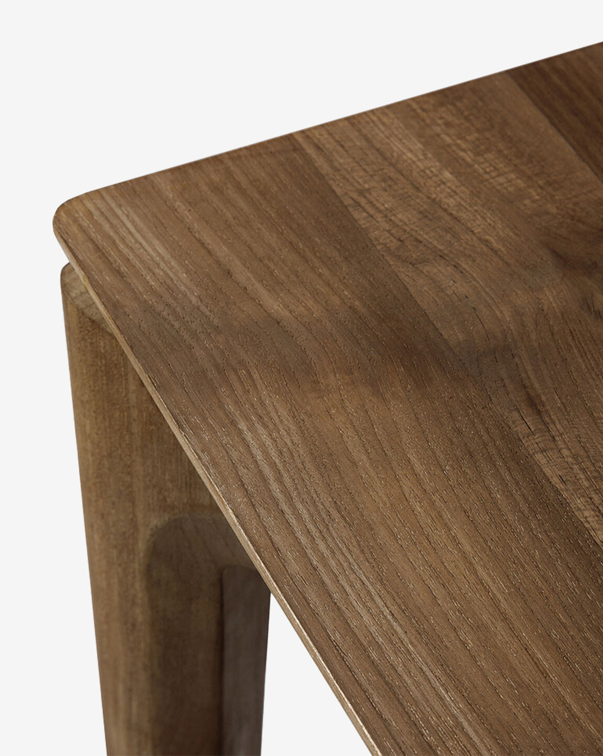 Close-up of the Alec Dining Table corner reveals its smooth finish and natural wood grain, with gently rounded edges and solid legs that emphasize its sturdy design—an ideal centerpiece for any dining space, by McGee & Co.