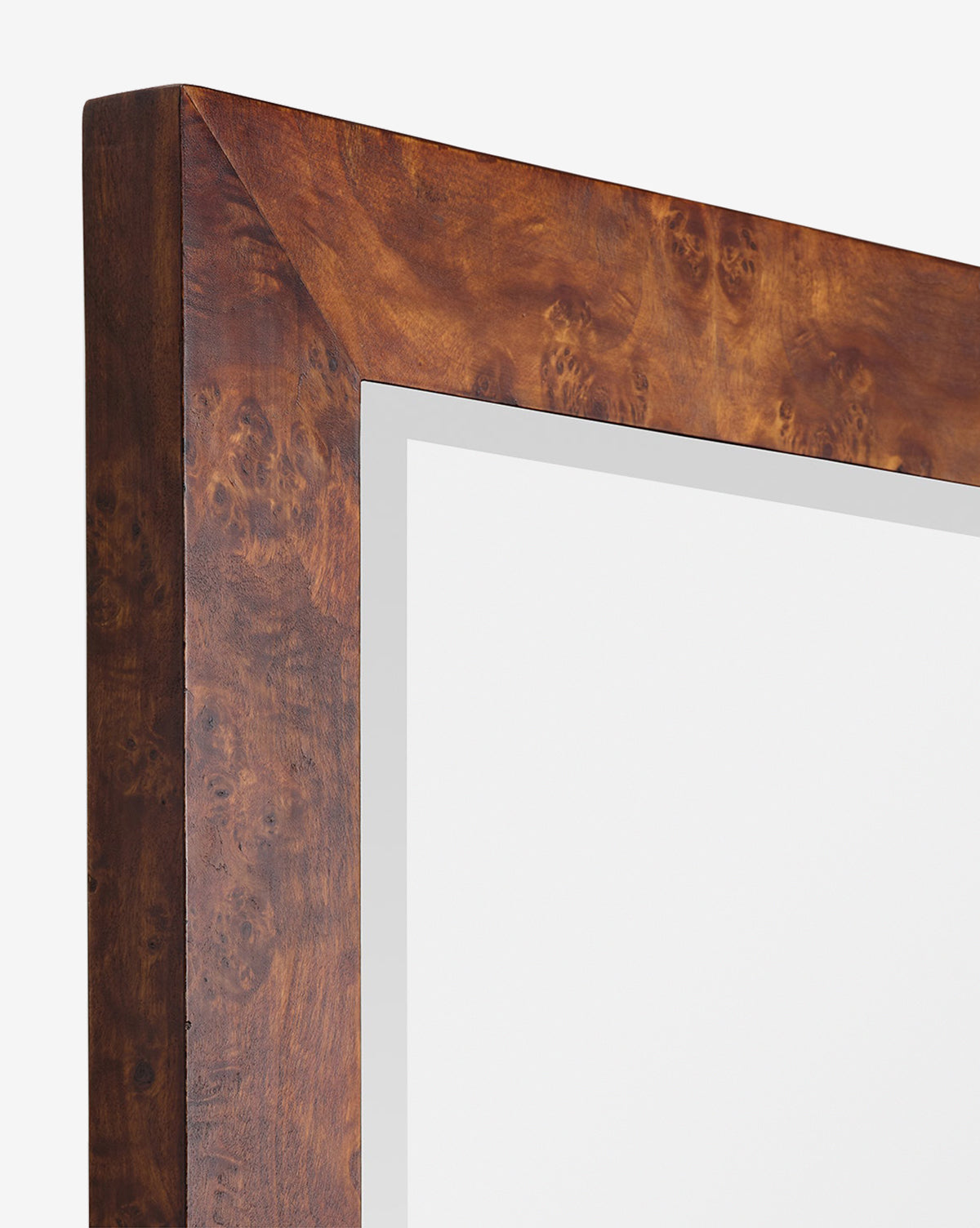 Close-up of the Alexia Rectangular Mirror’s corner, showcasing its wide, glossy burl wood frame with a rich brown pattern—a stylish statement piece against a white background, by McGee & Co.