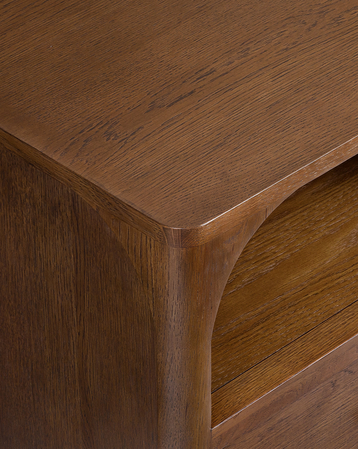 Close-up of the Ambrosia Nightstands corner, highlighting its smooth curved edge and the visible wood grain of its rich brown walnut oak veneer, by McGee & Co.