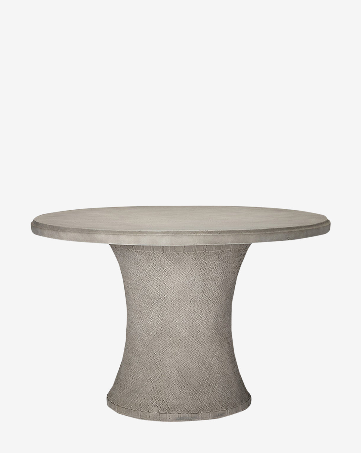 The Andrea Dining Table by Made Goods features a round, gray stonecast top and a flared, textured pedestal base with a basket weave design, shown against a plain white background. McGee & Co.