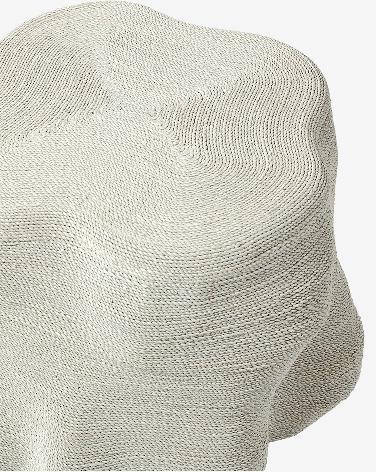 The Aphra Side Table features sculptural curves and folds, wrapped in light beige textured knit fabric with visible stitches—its soft material and organic shape make it an ideal accent piece for stylish living rooms, by McGee & Co.