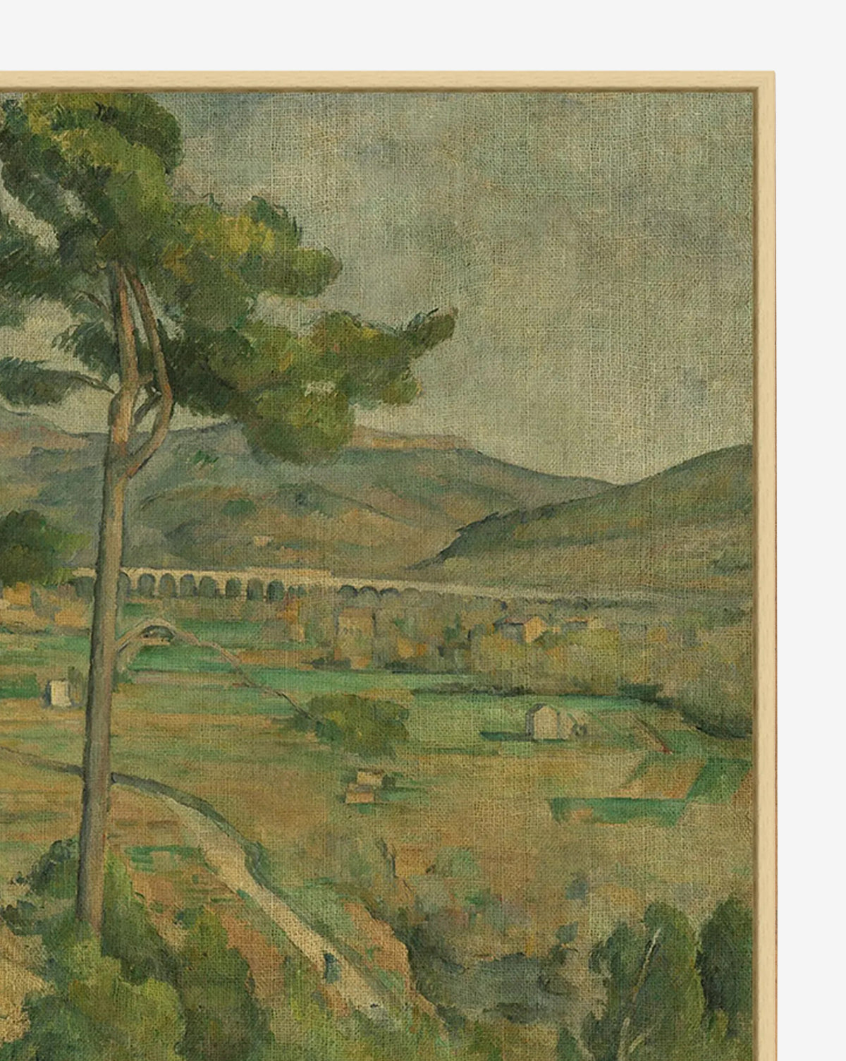 Arc River View is a framed artwork featuring a traditional landscape with a tall leafy tree, green fields, scattered houses, distant hills, and a long arched bridge crossing the river under a cloudy sky, by McGee & Co.