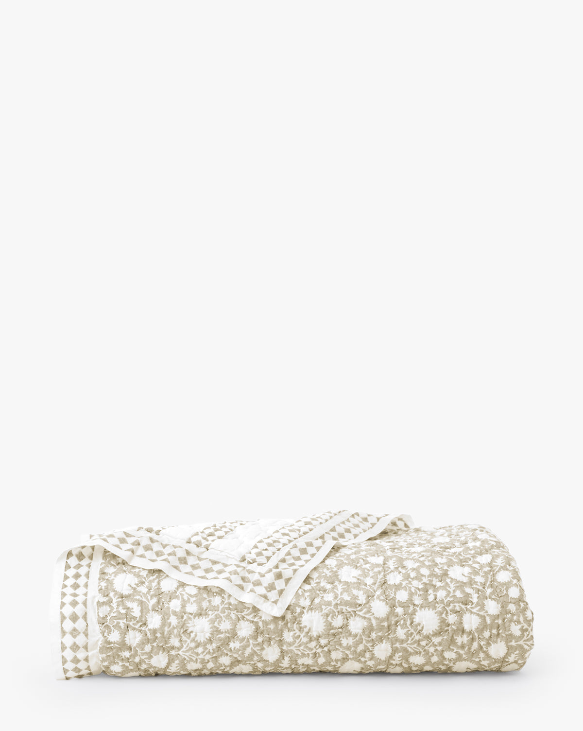 The Arcadia Block Print Kids Quilt features a beige and white floral pattern with a checkered border, shown folded against a plain white background.