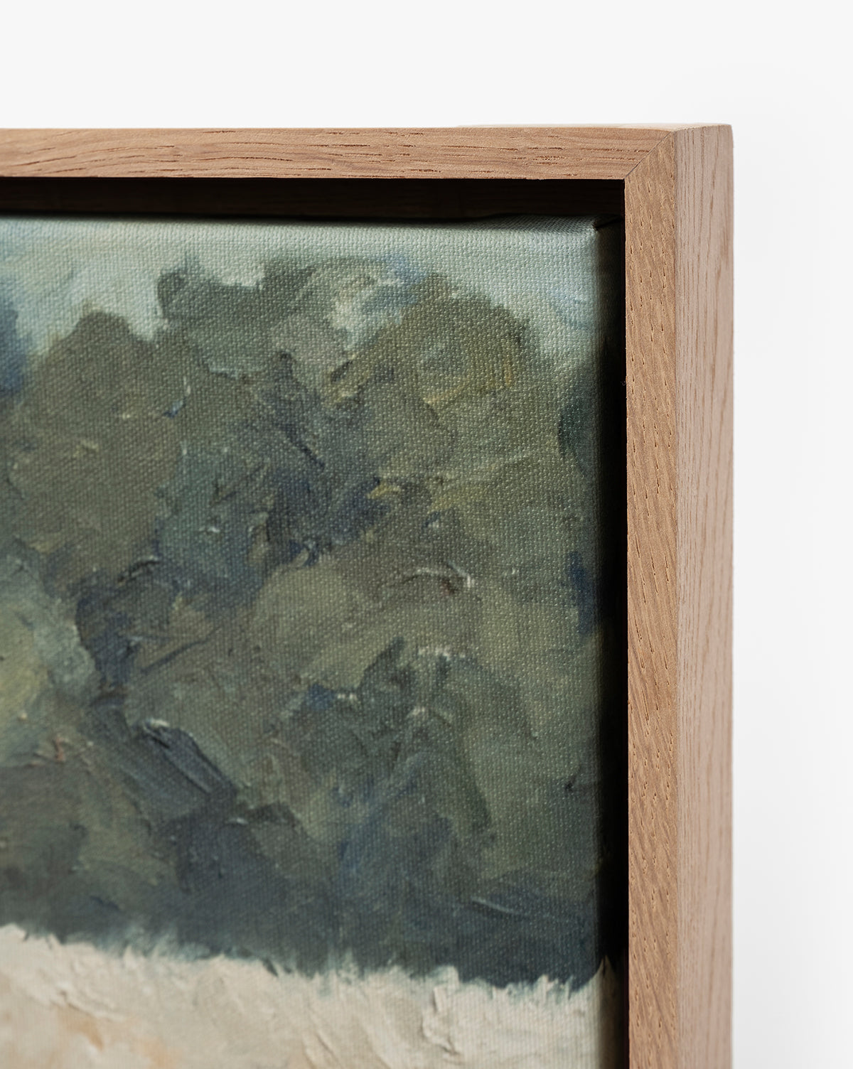 Close-up of the corner of Around the Bend, a framed painting with a wooden frame and impressionistic landscape featuring green foliage—a gallery-quality fine art print, by McGee & Co.