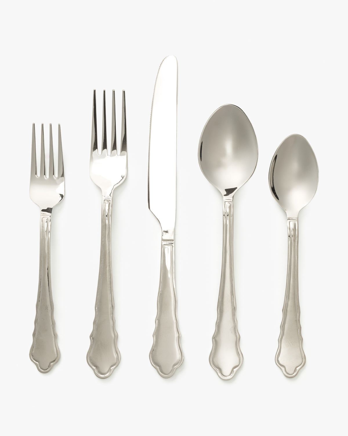 The Artois Flatware Set of 5—two forks, a knife, a tablespoon, and a teaspoon—features matching ornate handles and is arranged side by side on a plain white background by McGee & Co.