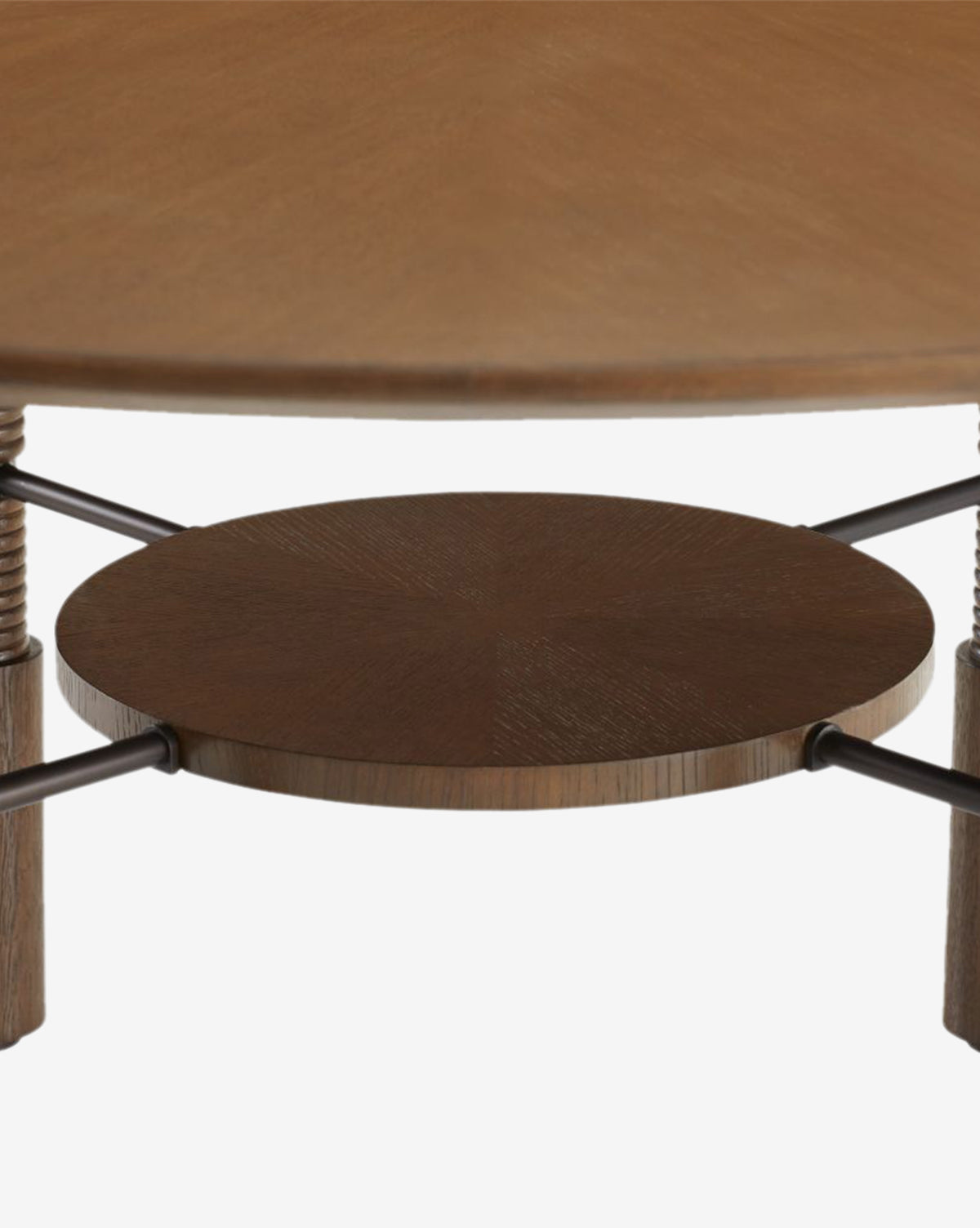 Close-up of the Ashford Dining Table, featuring a round oak veneer top, lower circular shelf, metal rods, and wooden legs for a vintage-inspired style, by McGee & Co.