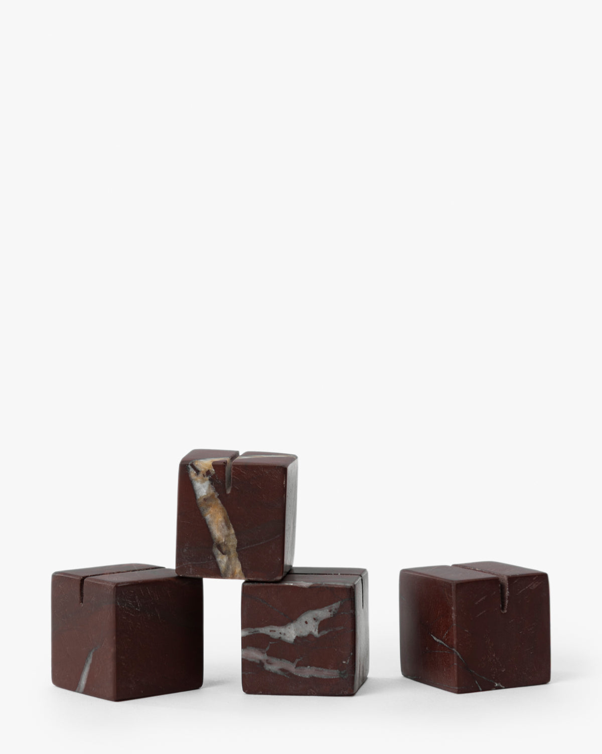 Four Auburn Marble Place Card Holders (Set of 4) with light veining are arranged pyramid-style on a white background—ideal for harvest tablescapes or holiday gatherings, by McGee & Co.