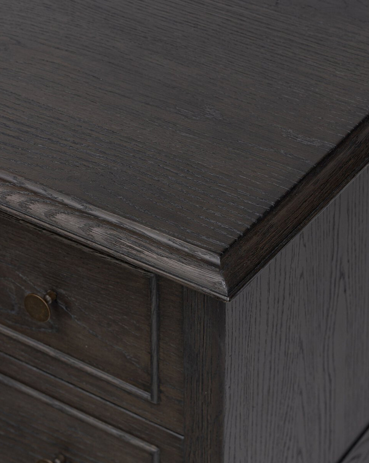 Close-up of the Aurelian Nightstand in smoked oak, showcasing its textured wood grain, beveled edge, and a drawer with a round metal knob—an elegant choice for bedroom storage, by McGee & Co.