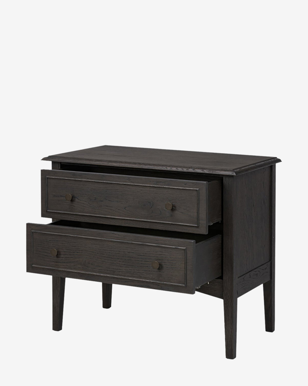 The Aurelian Nightstand is a modern dark smoked oak dresser with two partially open drawers, round handles, and four tapered legs, providing elegant bedroom storage, by McGee & Co. Photographed against a plain white background.