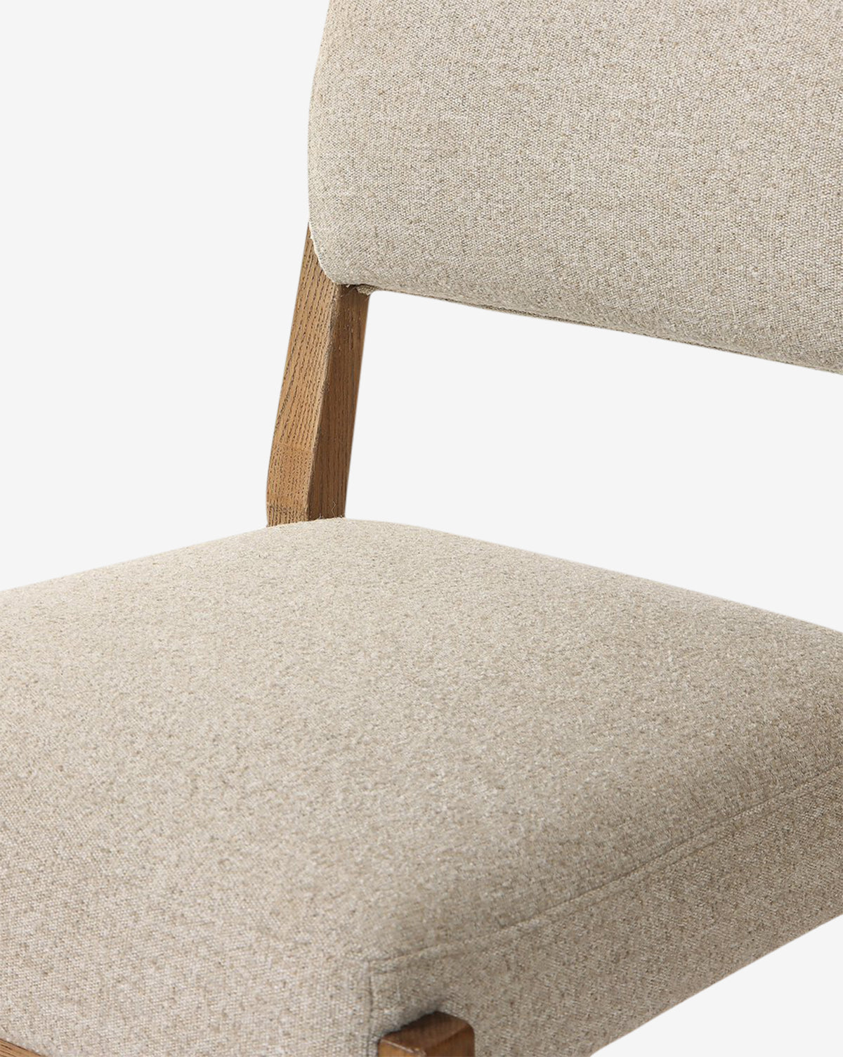 Close-up of the Bailey Dining Chair, featuring an upholstered beige seat and backrest with a smoked oak wooden frame, set against a white background, by McGee & Co.