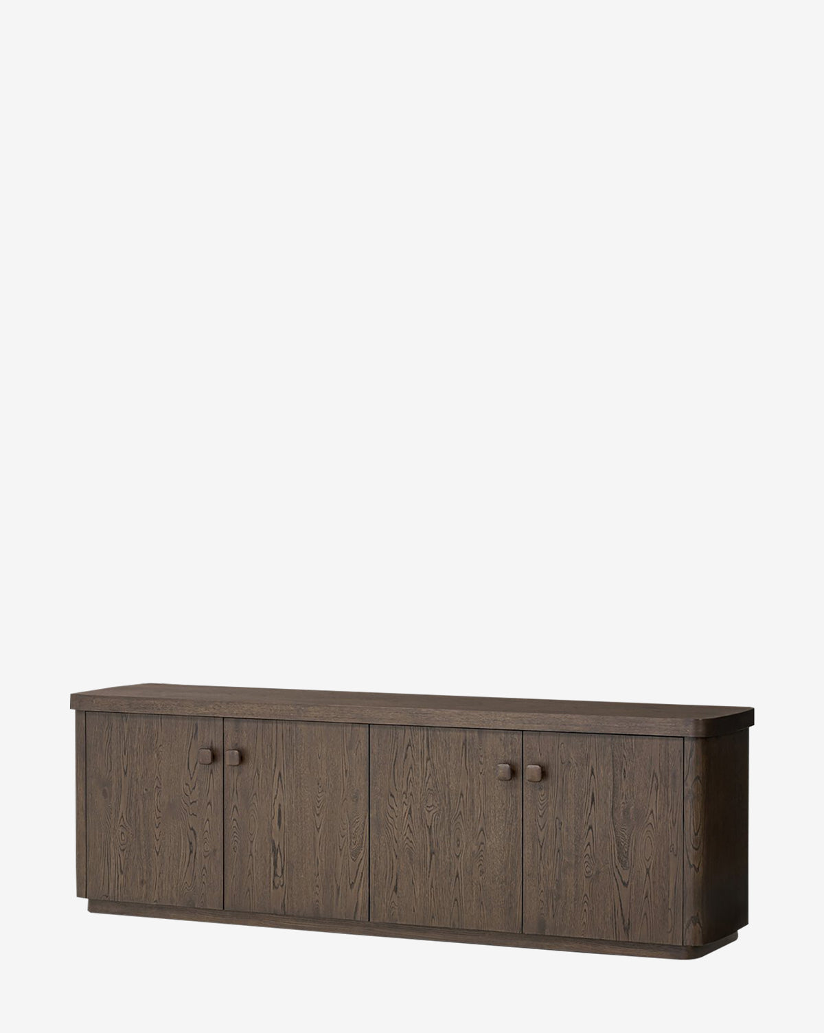 The Baldwin Sideboard features a modern, minimalist design with four doors, round handles, and a smooth brown oak veneer finish that highlights its subtle wood grain, by McGee & Co.