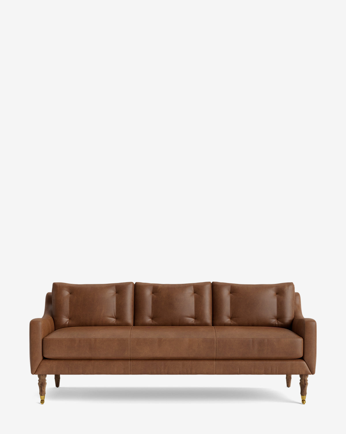 The Barden Sofa 84 is a modern, mid-century brown leather sofa with three seat and three back cushions, highlighted by reeded wood legs with brass caps, shown on a plain white background by McGee & Co.
