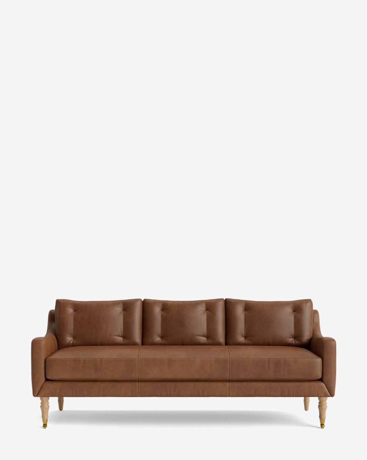 The Barden Sofa 84 showcases brown leather upholstery, three tufted cushions, slim armrests, and reeded wood legs, set against a plain white background, by McGee & Co.