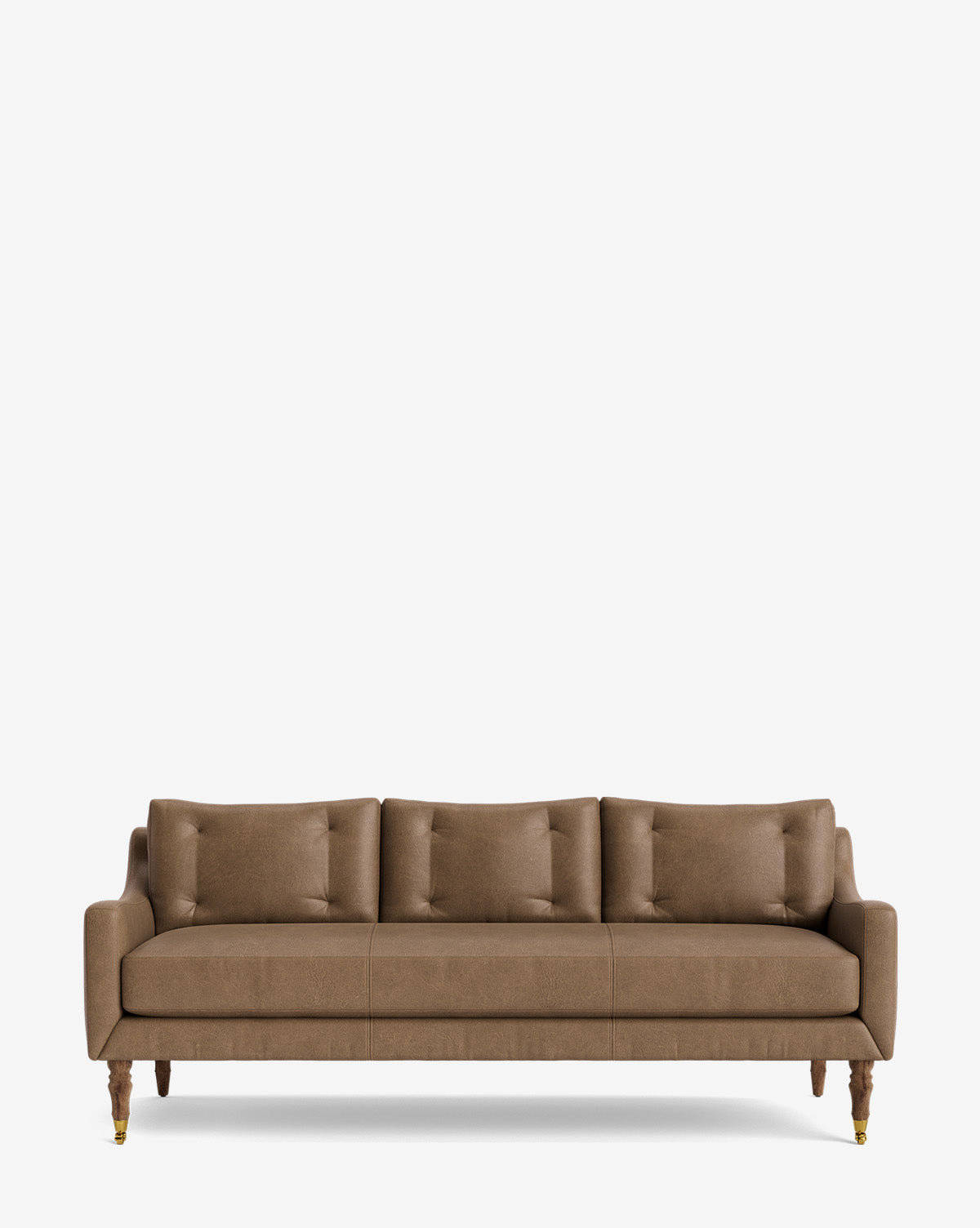 A modern brown Barden Sofa 84 with tufted cushions, four matching back cushions, and reeded wood legs with brass castors, shown against a plain white background by McGee & Co.