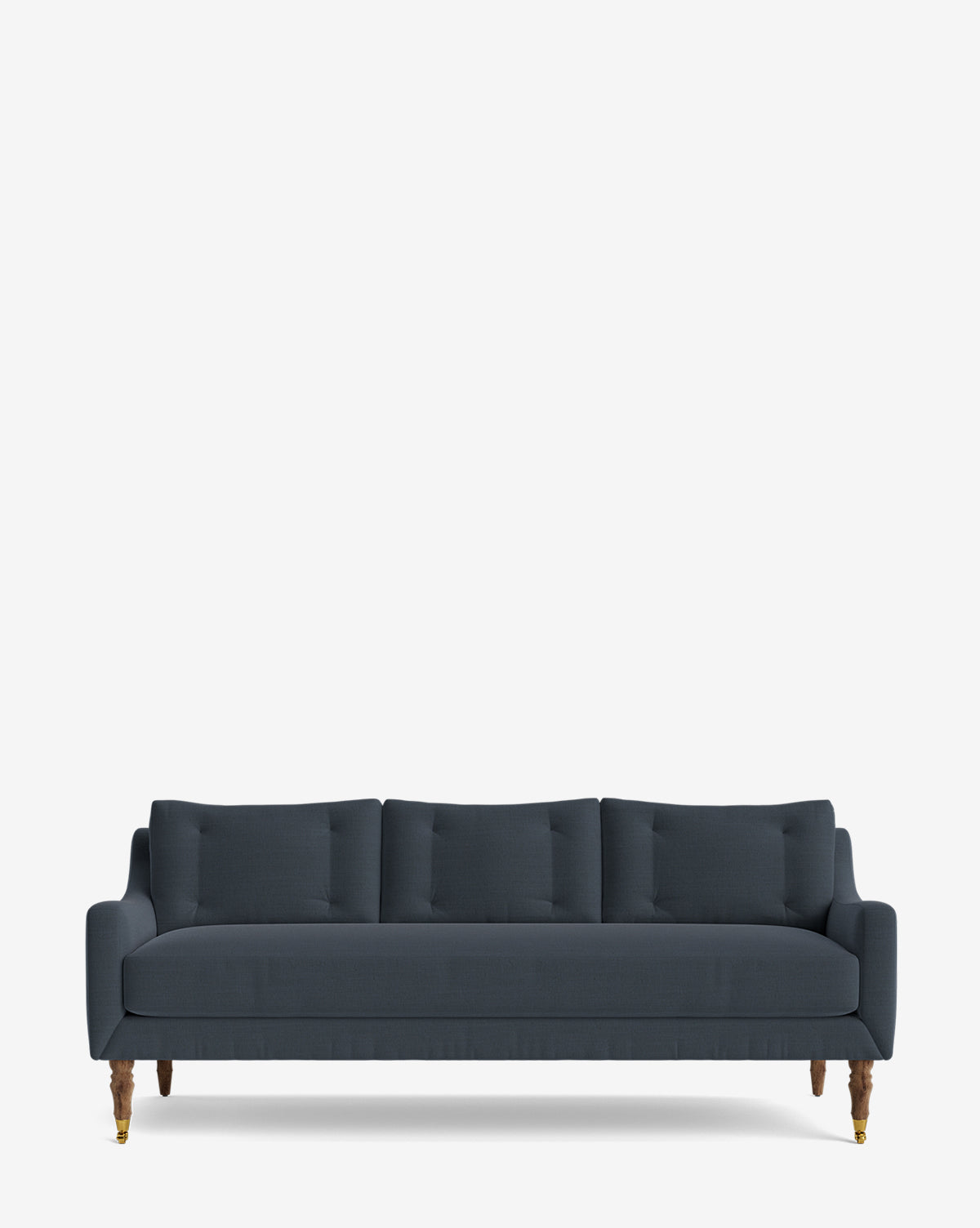 The Barden Sofa 84 is a dark blue, three-seater with tufted back cushions and elegant reeded wood legs, shown against a plain white background, by McGee & Co.