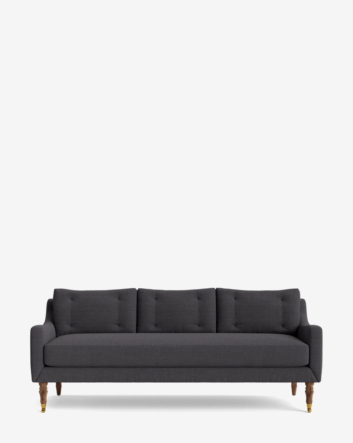The Barden Sofa 84 is a dark gray, three-seater with tufted cushions and elegant reeded wood legs, shown against a plain white background by McGee & Co.