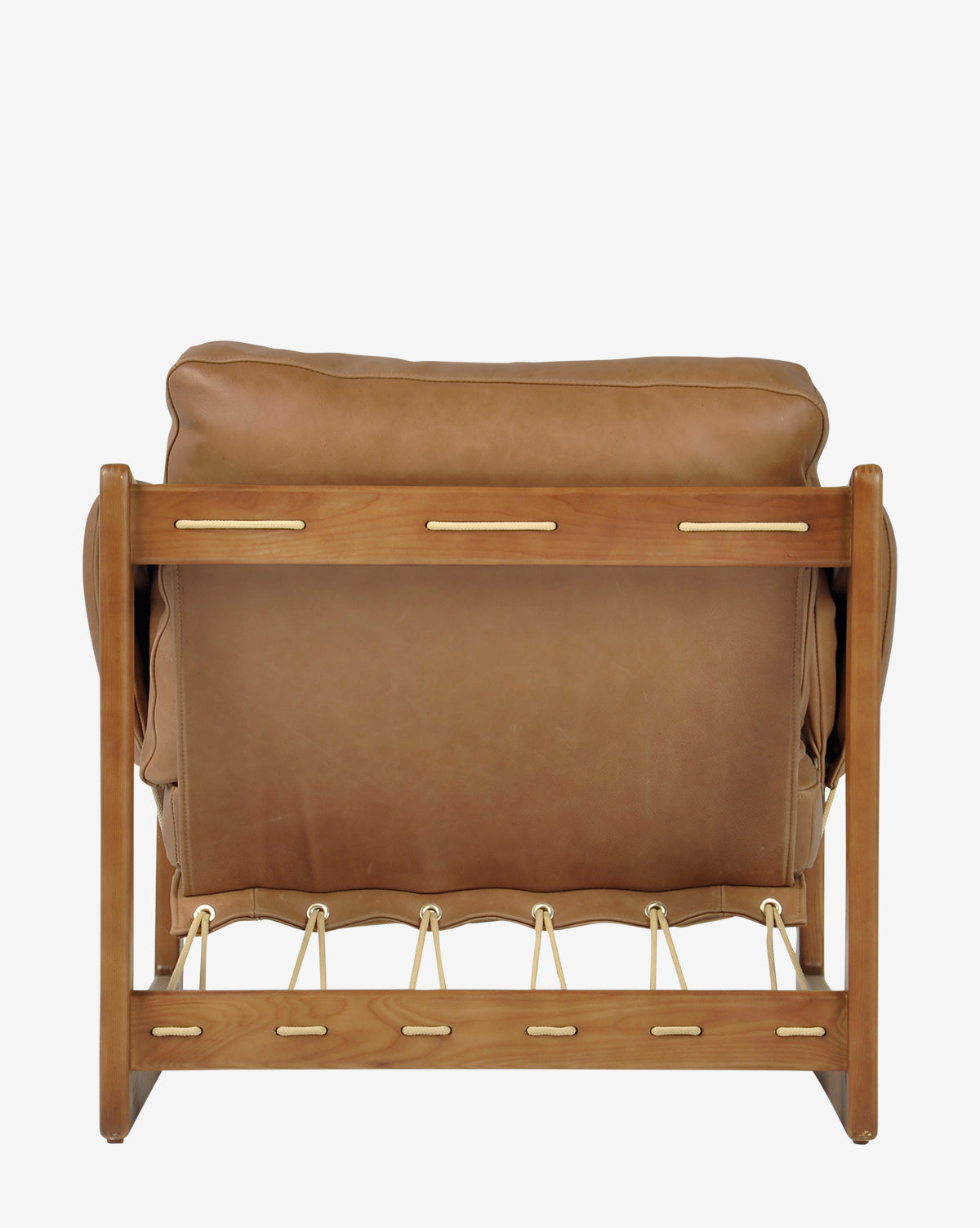 The Barker Lounge Chair, shown from the back in tan top-grain leather with a wooden frame and gold accents, features visible joints that capture the refined elegance of midcentury sling seating, by McGee & Co.