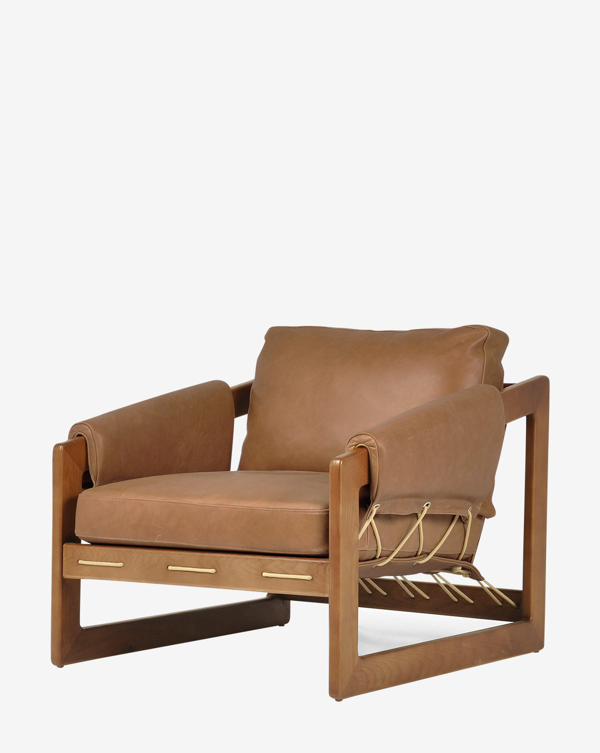 The Barker Lounge Chair features a wooden frame, top-grain leather tan cushions, and rope detailing along the sides and back, taking inspiration from midcentury sling seating, by McGee & Co. Shown here against a plain white background.