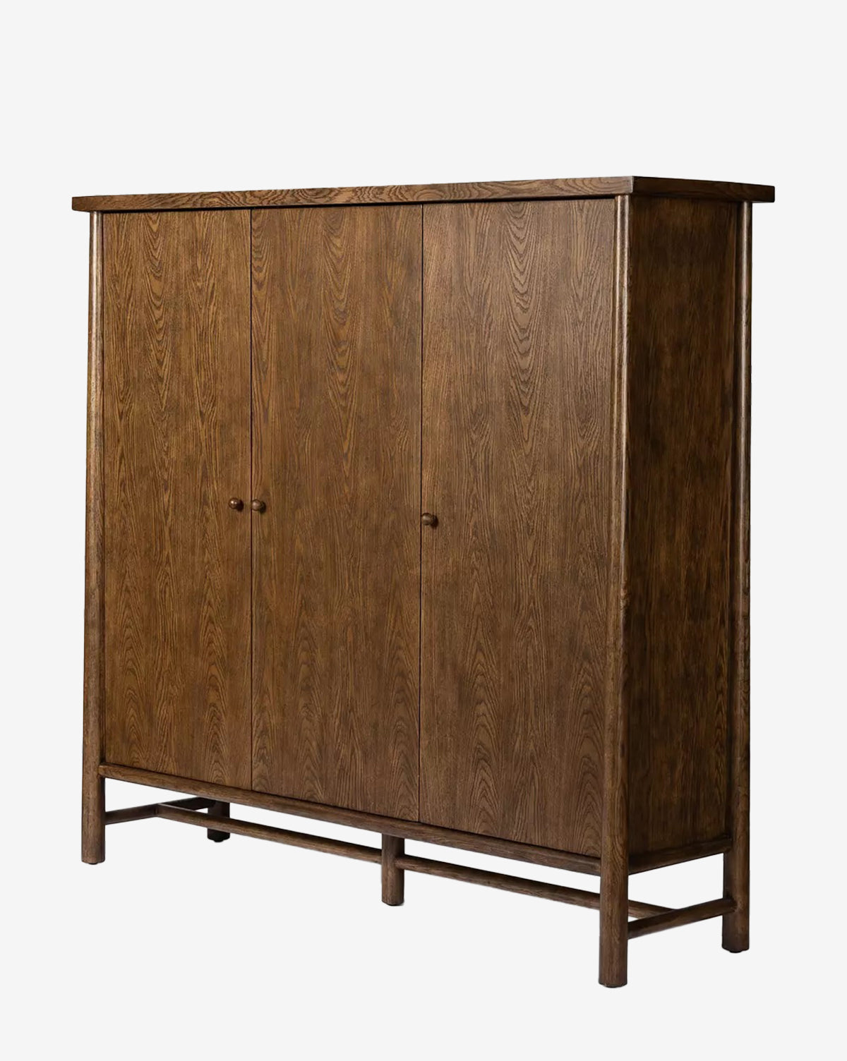 The Beasley 3-Door Cabinet features a tall, minimalist rectangular design with three closed doors, simple round knobs, and a dark toasted oak wood grain finish, by McGee & Co.