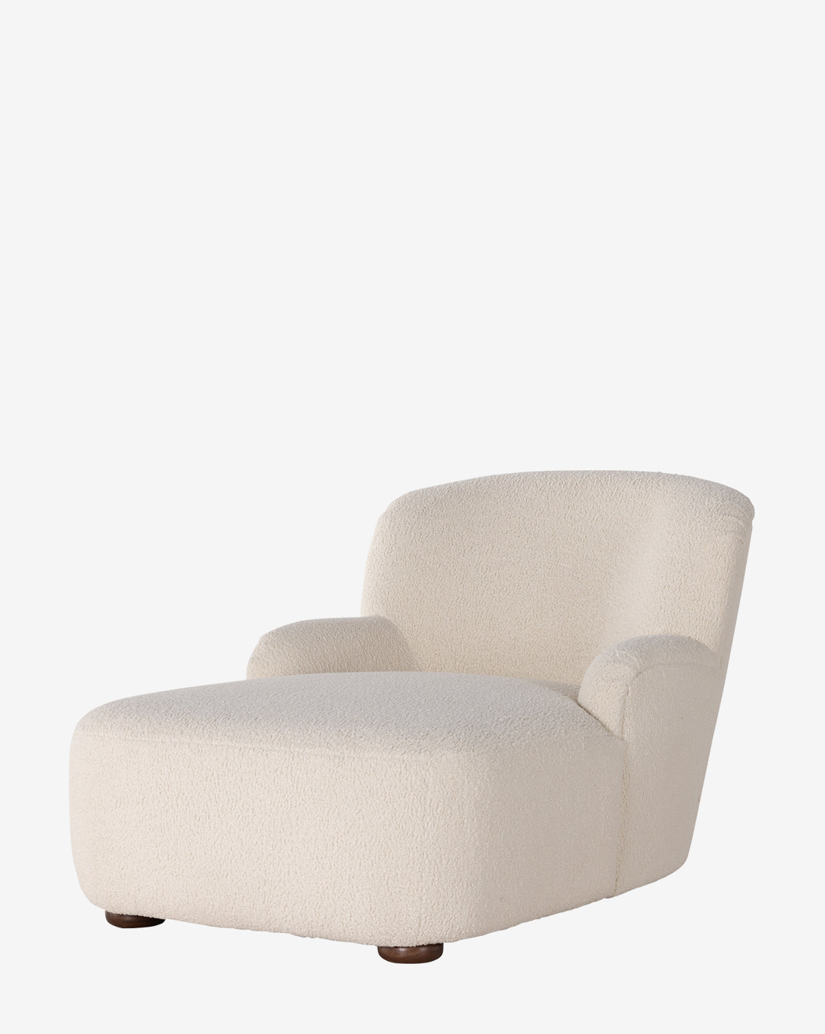 The Berrett Chaise Lounge features plush cream shearling upholstery, rounded edges, and short dark wooden legs, offering cozy comfort and modern style to any living space, shown against a plain white background by McGee & Co.
