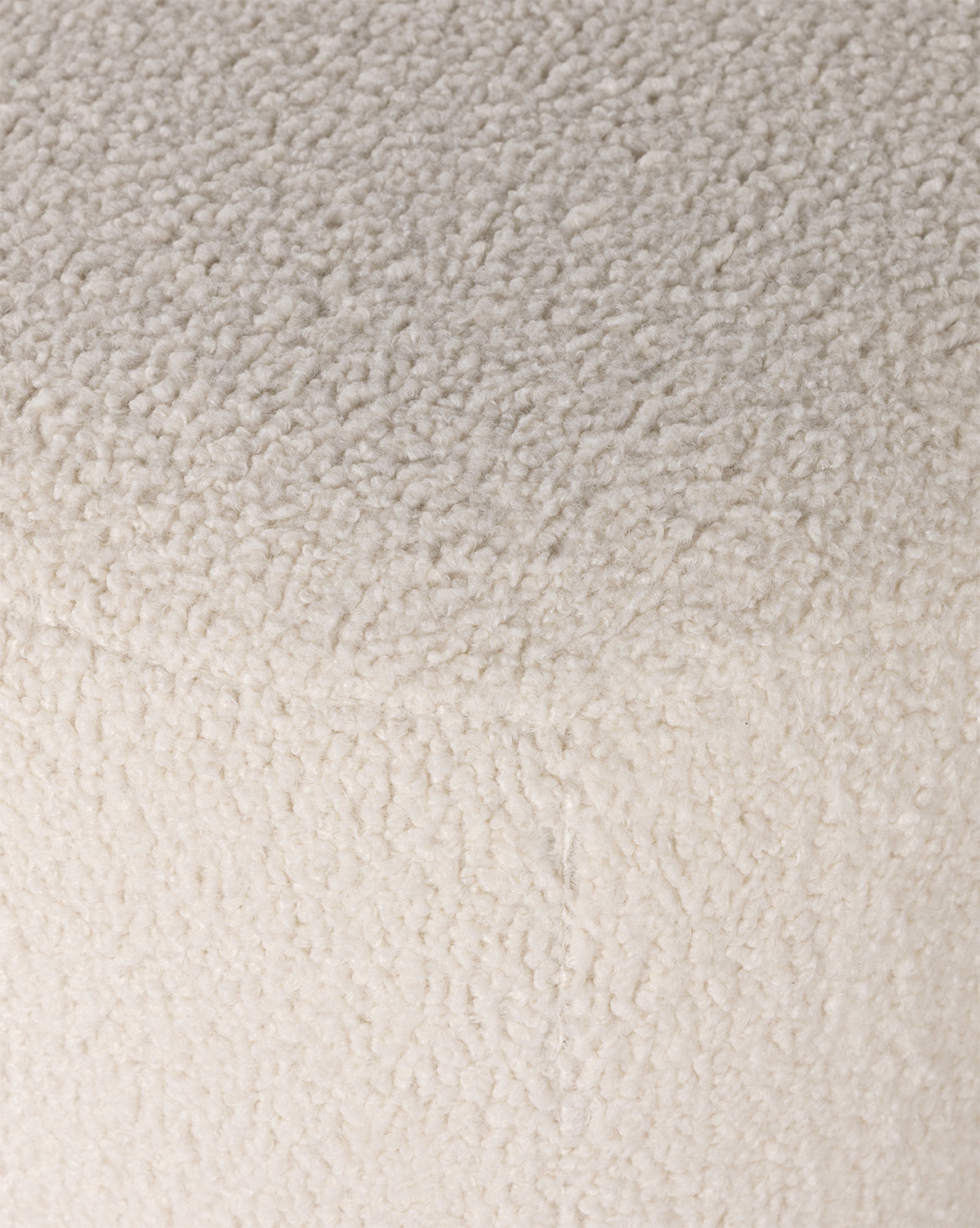 Close-up of the soft, textured off-white upholstery on the Berrett Chaise Lounge, featuring small, curly fleece-like fibers—ideal for bringing cozy comfort to your living space, by McGee & Co.