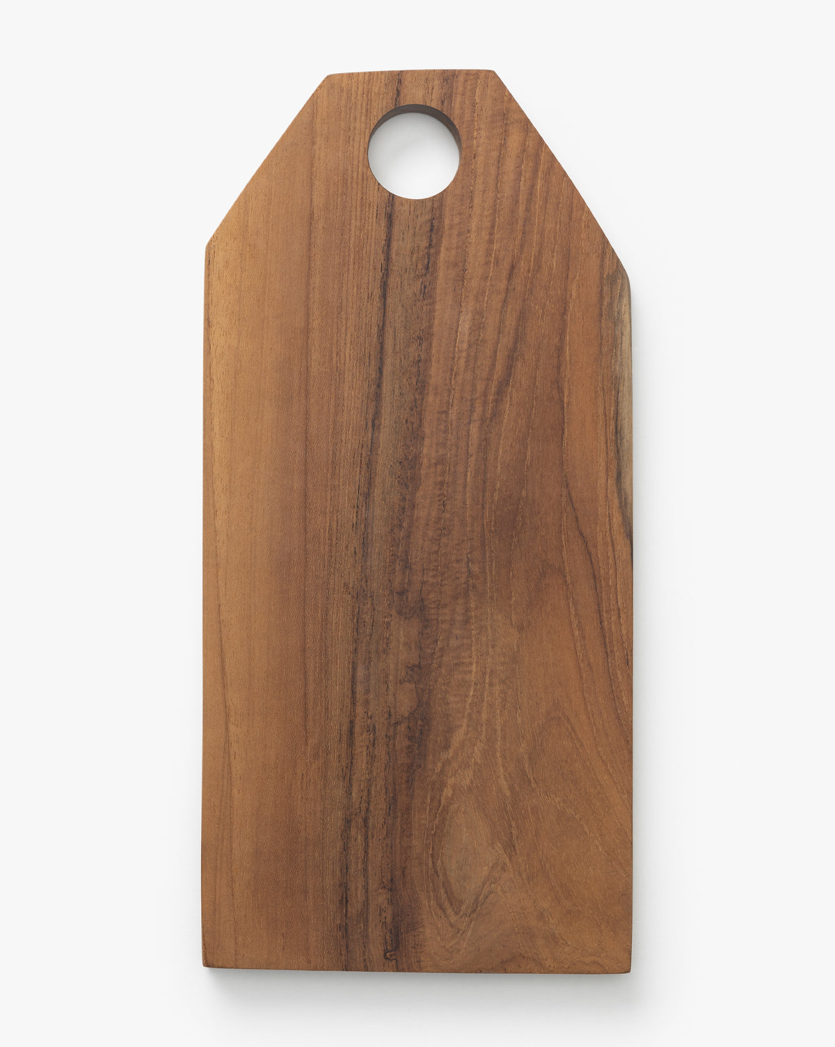 The Bevelled Edge Cutting Board is a rectangular wooden kitchen staple with a pointed top and circular hole near the edge, displayed against a white background by McGee & Co.
