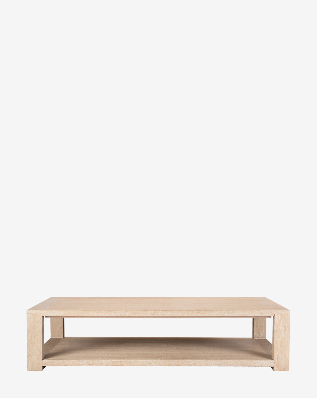 The Boone Coffee Table showcases a rectangular light wood frame, an open lower shelf, and a bleached oak finish, offering a contemporary look, by McGee & Co.
