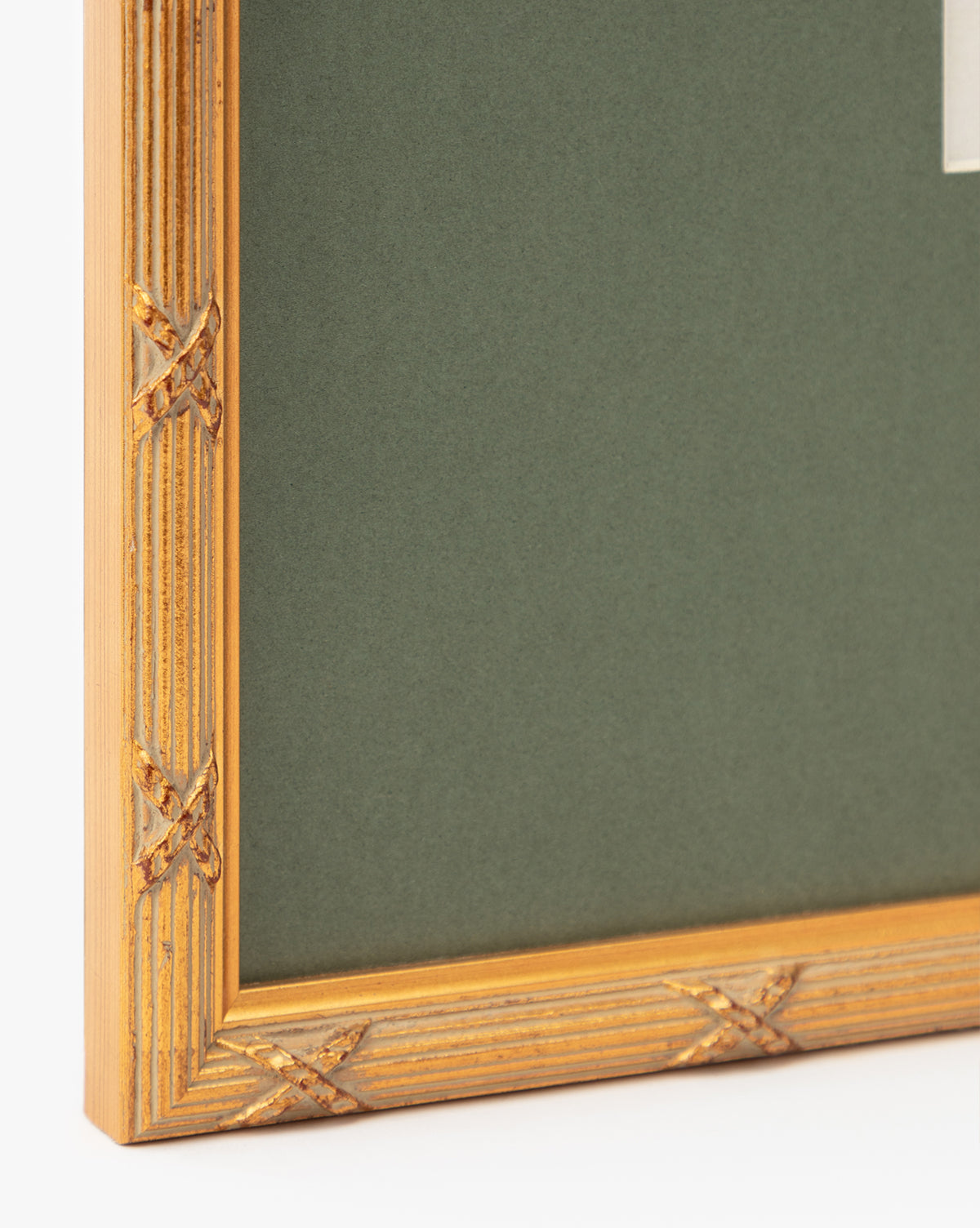 Close-up of the corner of a gold frame with decorative carved detailing and a dark green mat, adding an elegant touch to display Botanical Grid 2 as gallery-quality art, by McGee & Co.