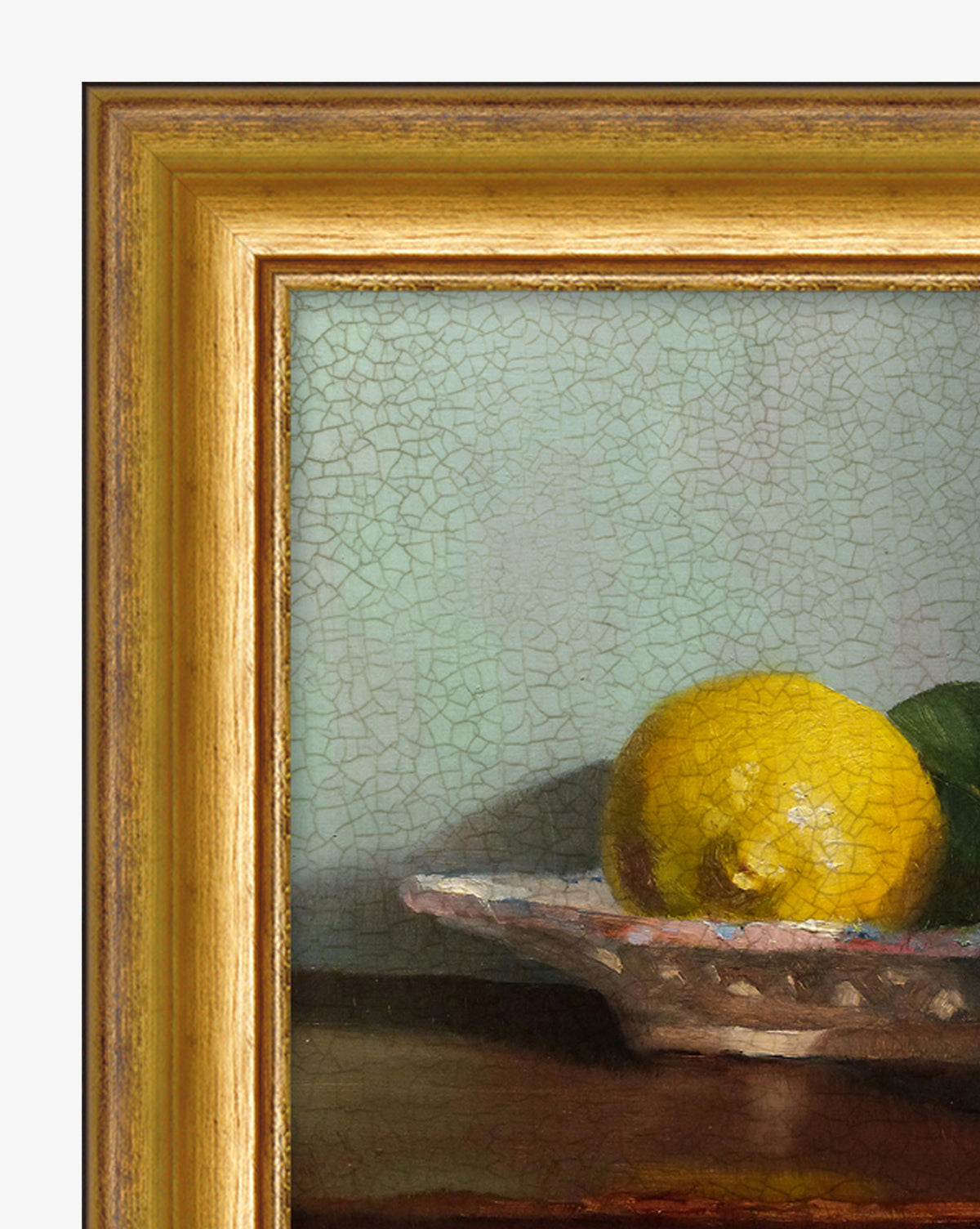 A close-up of the framed Bowl of Lemons print features yellow lemons and green fruit on a patterned plate, set against a textured background. The vintage golden brown frame makes it ideal kitchen decor.