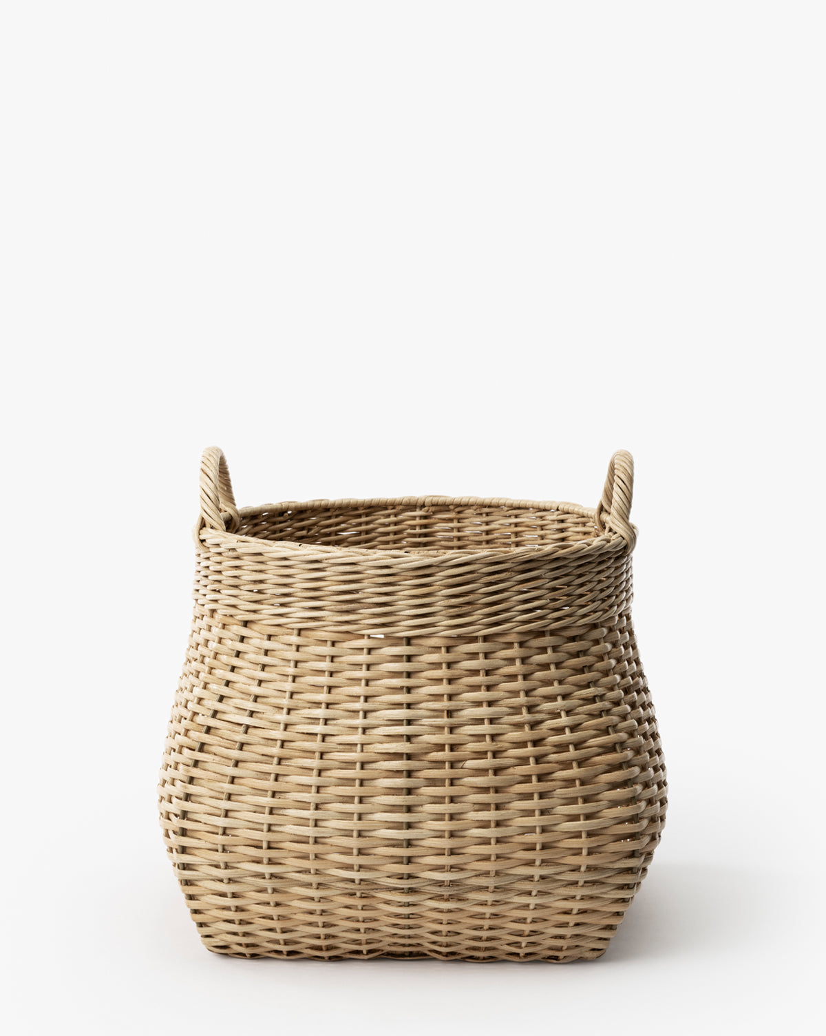 The Boyce Woven Basket features a rounded rectangular shape, two handles, and a tight, uniform weave, shown against a plain white background by McGee & Co.