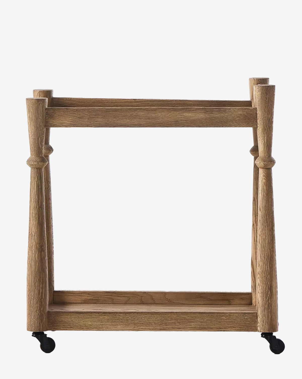 The Brendal Bar Cart features a solid oak rectangular frame, four sturdy vertical posts, a lower shelf for drinkware, and black caster wheels. Its design is both minimalist and rustic, by McGee & Co.
