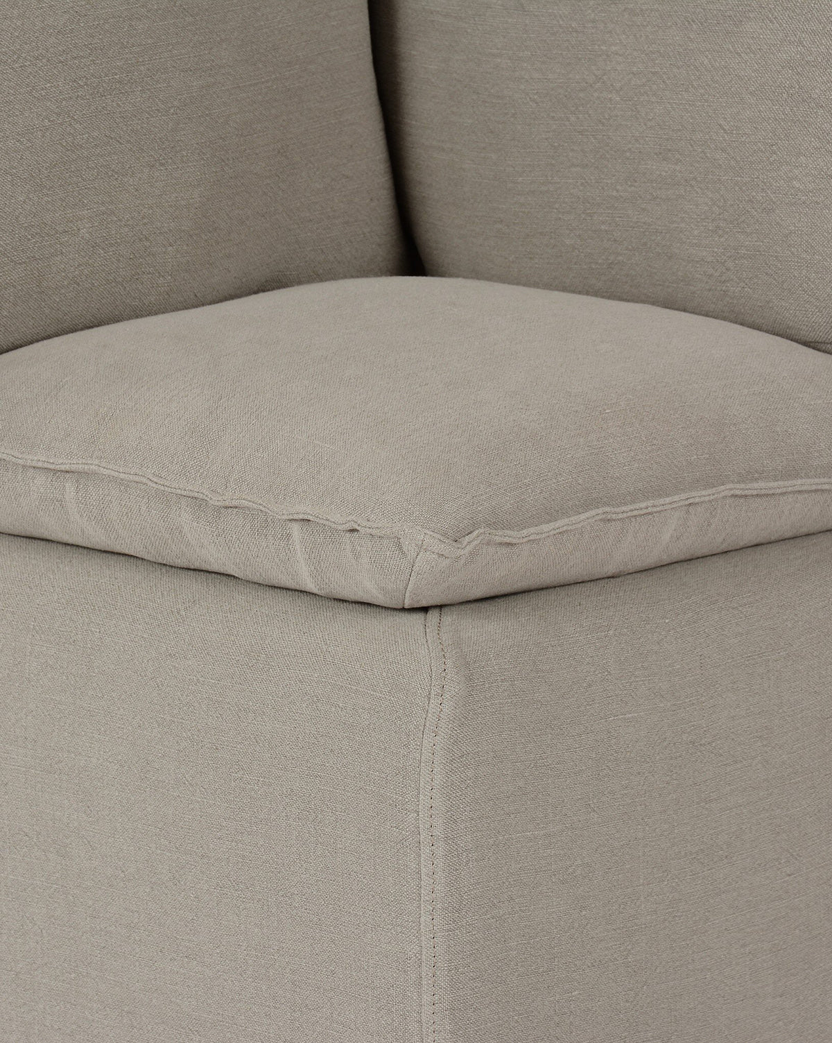 Close-up of the Brookings Slipcover Corner showcases its light gray linen-blend fabric, plush cushions, and detailed stitching, by McGee & Co.