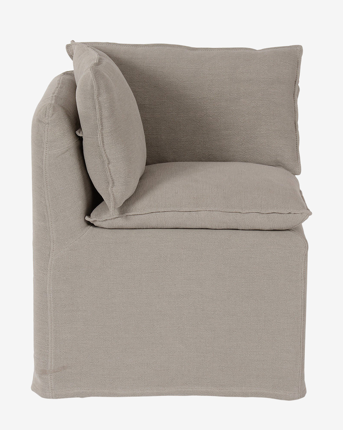 The Brookings Slipcover Corner is a beige, upholstered armless corner chair with plush cushions and linen-blend fabric, shown from the side against a plain white background, by McGee & Co.