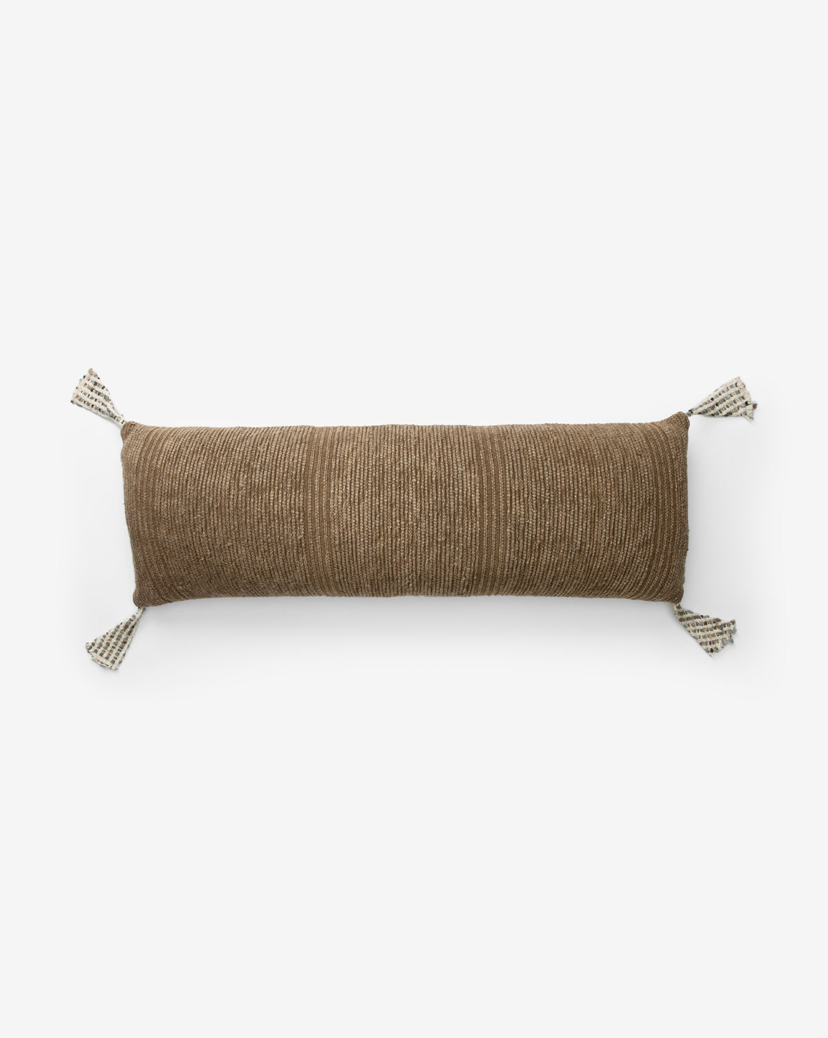 The Bruna Pillow Cover is a rectangular brown ribbed cover with subtle horizontal lines and four white tassels with black accents, shown against a plain white background by McGee & Co.