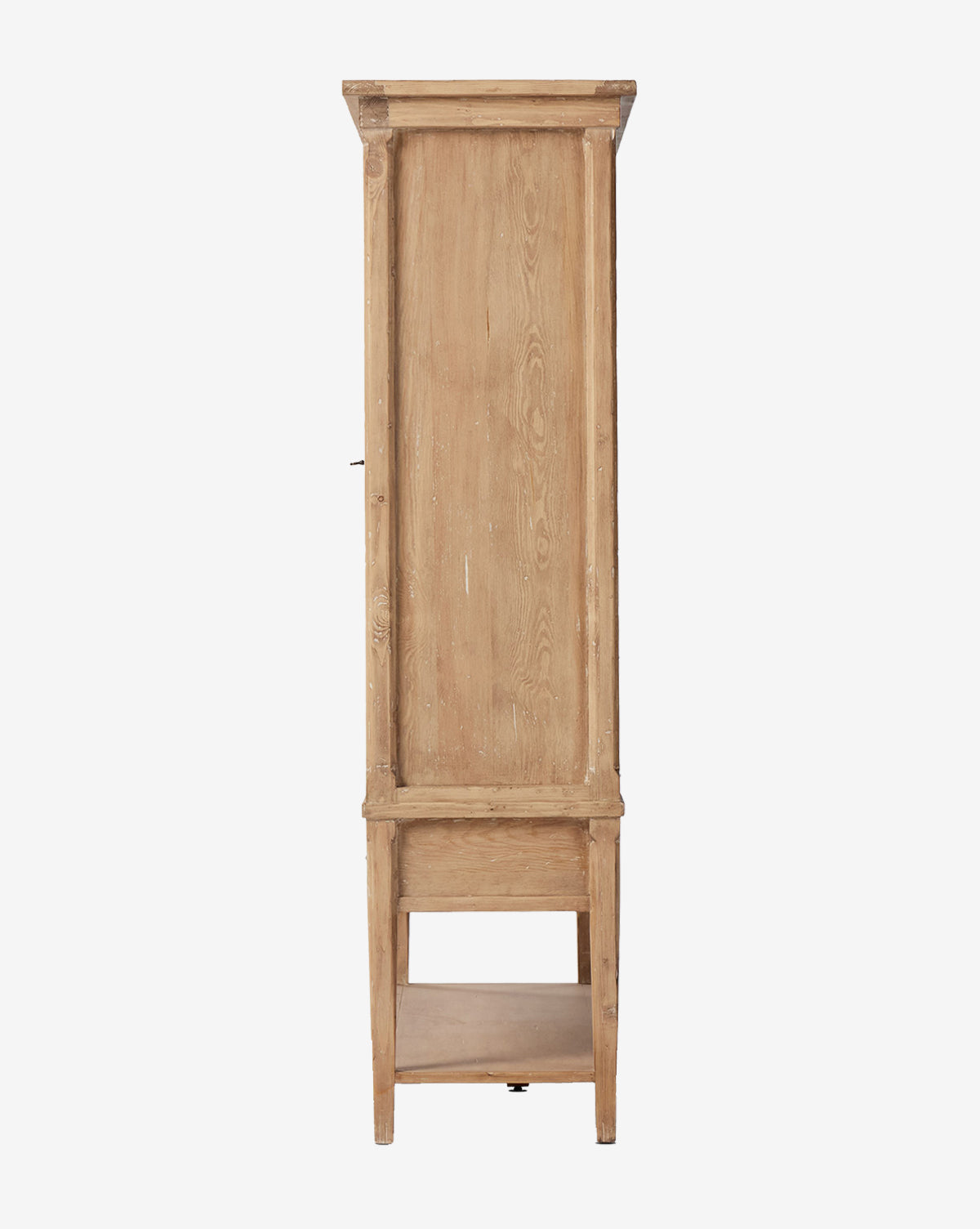 Side view of the Bryn Cabinet, made from solid pine with a natural light finish and visible grain. Features a simple rectangular design, an open bottom shelf, and distressed copper hardware on the door by McGee & Co.