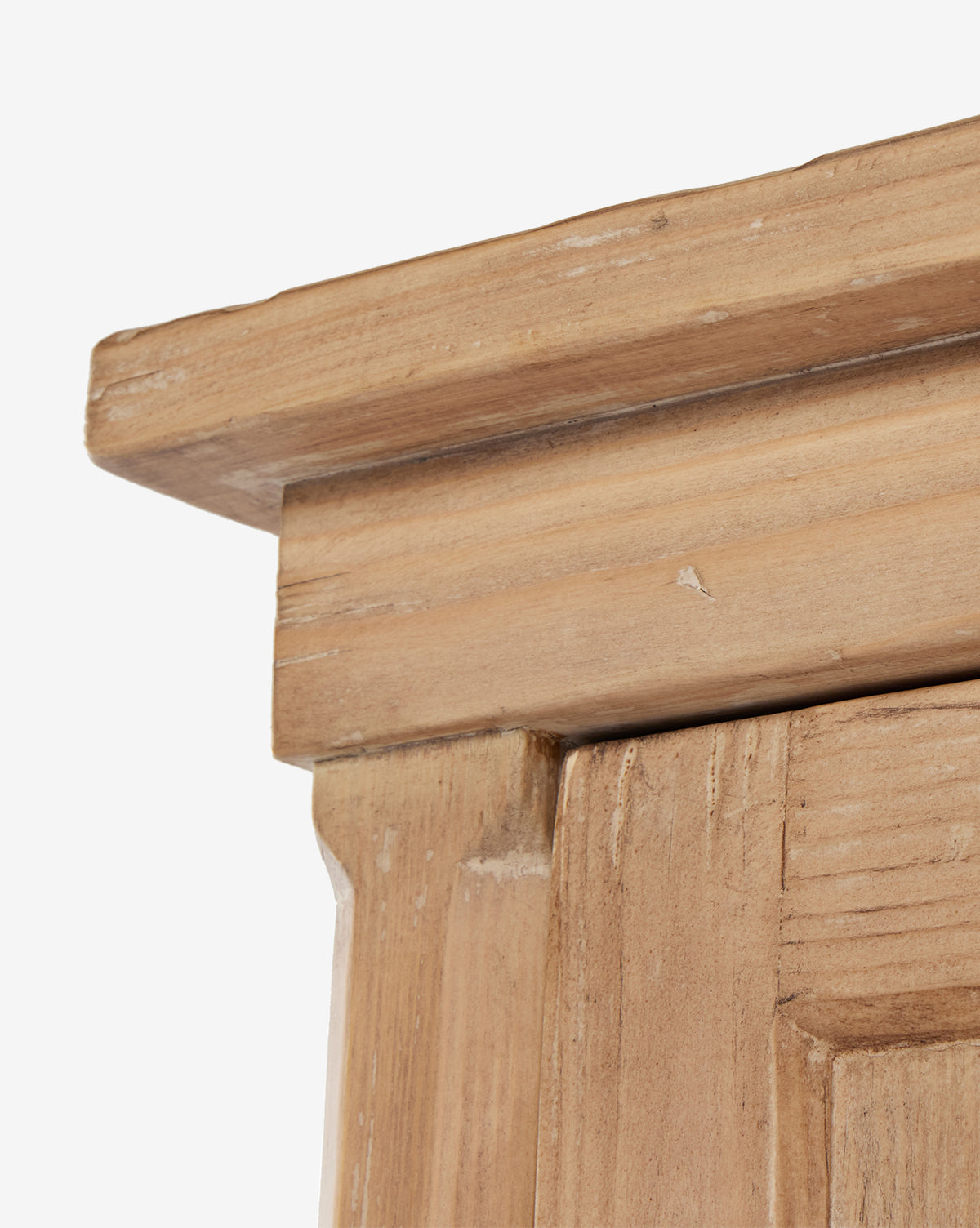 Close-up of the Bryn Cabinets top corner, showcasing its solid pine construction with visible grain, minor scratches, a natural finish, and detailed craftsmanship accented by distressed copper hardware, by McGee & Co.