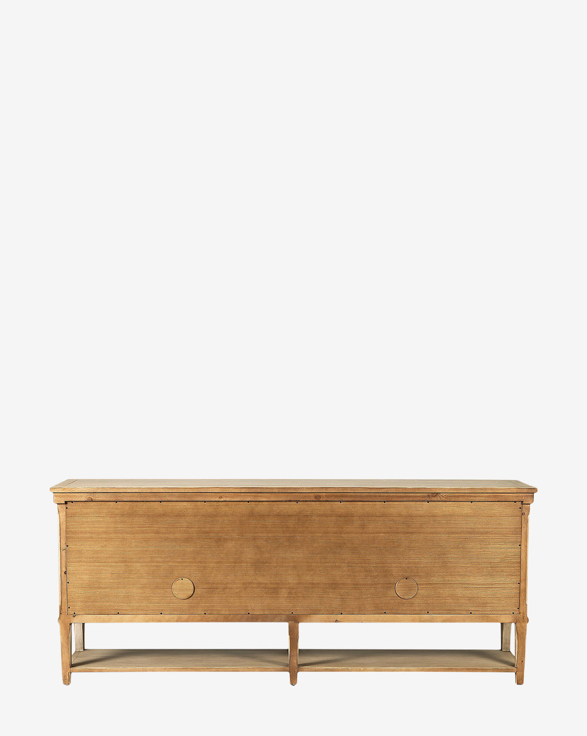 The Bryn Sideboard is a rustic, solid pine unit with a rectangular silhouette and minimalist design. It features two round, distressed copper handles, stands on four legs, and includes an open lower shelf for extra storage, by McGee & Co.