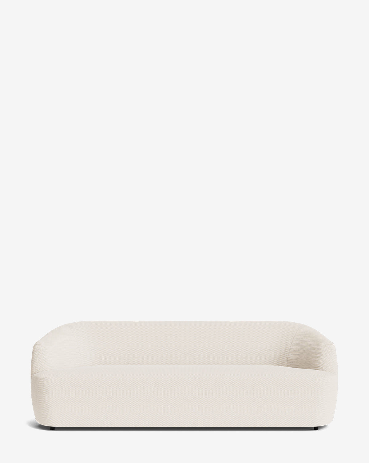 The Byron Sofa 96 is a modern, minimalist cream custom fabric sofa with rounded edges, a low backrest, and a curved back design that adds subtle elegance. Set against a plain white background, it complements any contemporary space by McGee & Co.