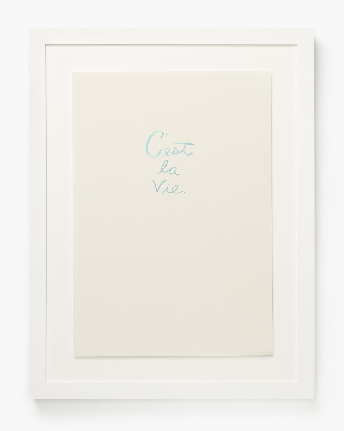 Showcase minimalist style with the C’est La Vie, featuring a white wood frame and handwritten light blue text centered on a plain white background—a timeless decor accent for any space, by McGee & Co.