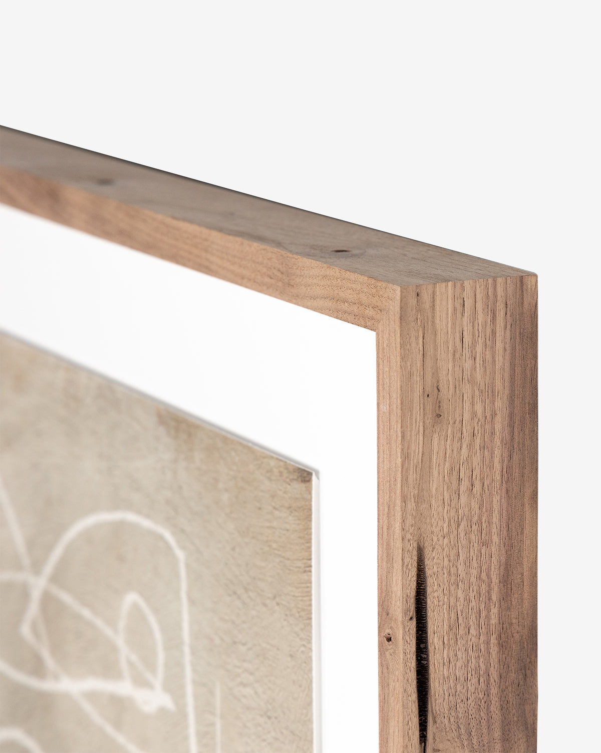 Close-up of the Change by Dan Hobday artwork in a natural-finish wooden frame, handmade in Austin, featuring a white mat and abstract white lines on a beige background.