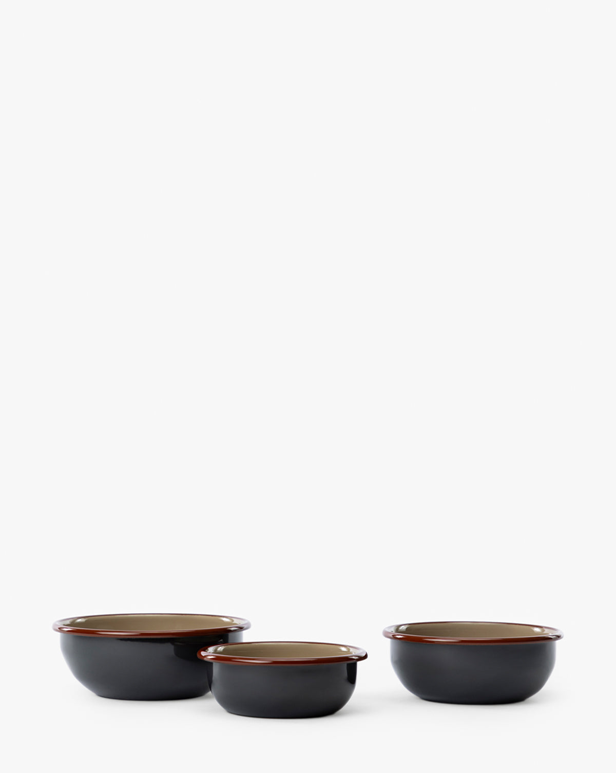 The Charles Enamel Bowls (Set of 3) features round, dark-colored bowls of different sizes with a glossy finish and brown rims, displayed side by side on a plain white background by McGee & Co.