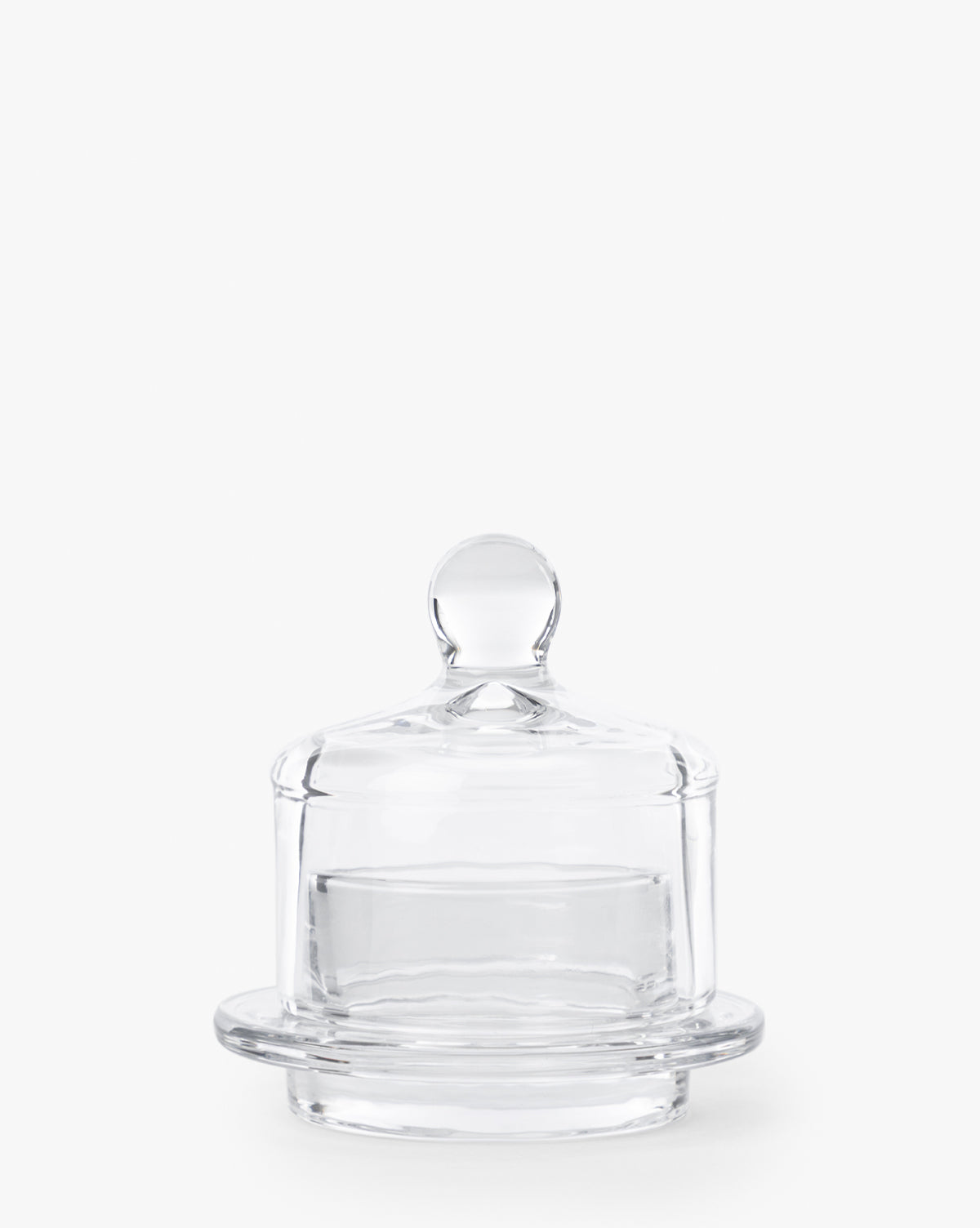 The Christian Glass Condiment Dish features a clear glass round lid with a knob handle, perfect for serving condiments, and comes with a matching glass base, shown against a plain white background, by McGee & Co.