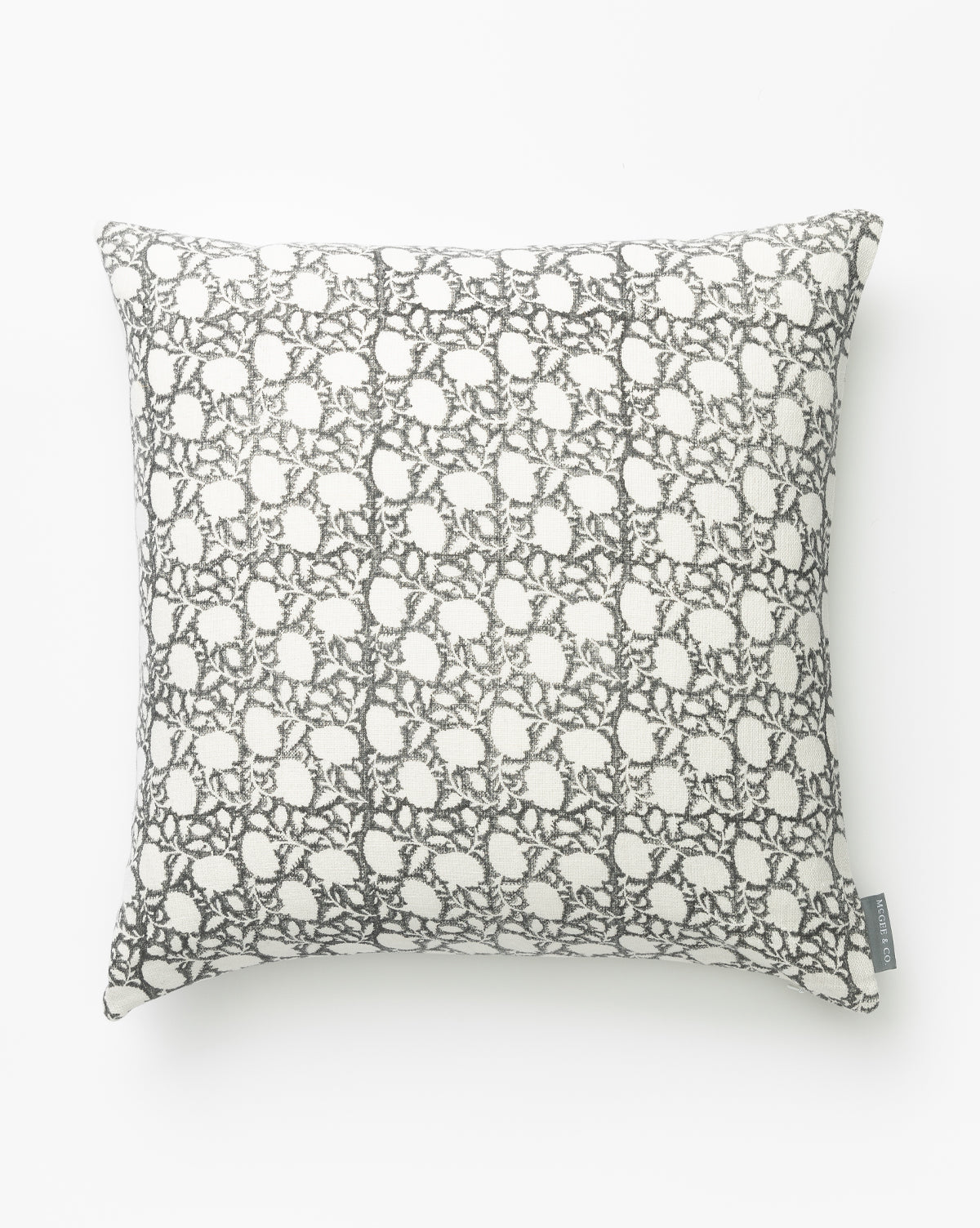 The Clara Block Print Pillow Cover features a white background with a detailed gray lace-inspired pattern, displayed on a plain white backdrop. A small fabric tag appears on the lower right edge, by McGee & Co.