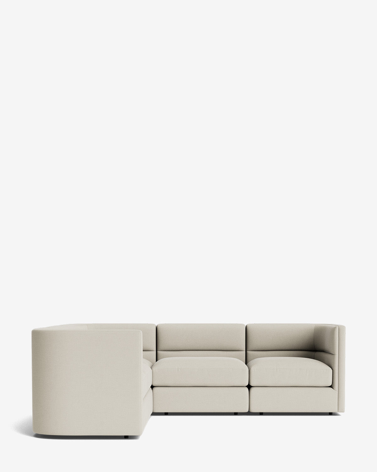 The Claremont Modular L Sectional 99 features clean lines and low backrests in light beige fabric, offering customizable style and comfort for contemporary spaces, by McGee & Co. Seen from an angle against a plain white background.