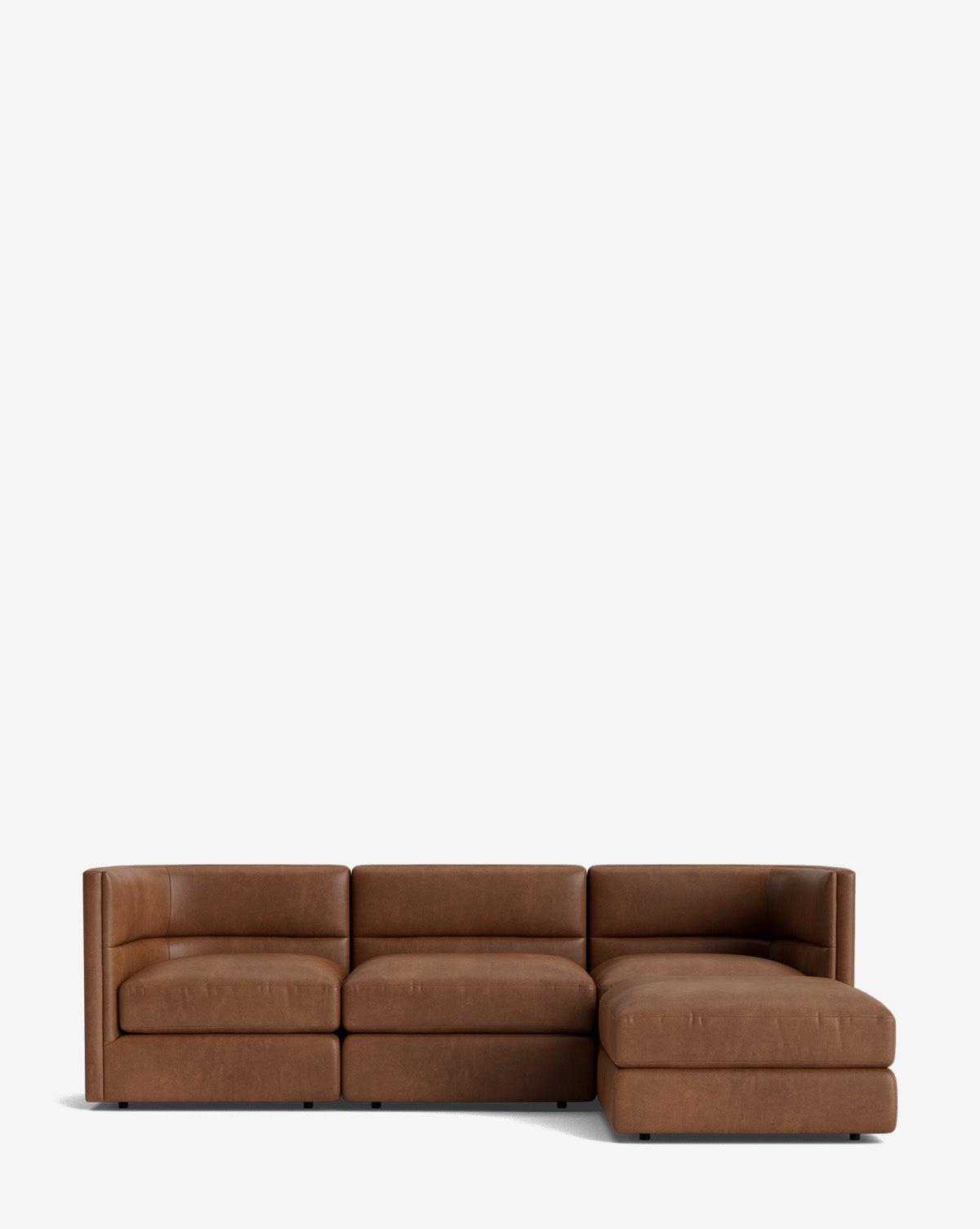 The Claremont Modular Sofa with Ottoman 99 is a modern brown leather three-seater with a right-side chaise and channeled back, shown against a plain white background by McGee & Co.